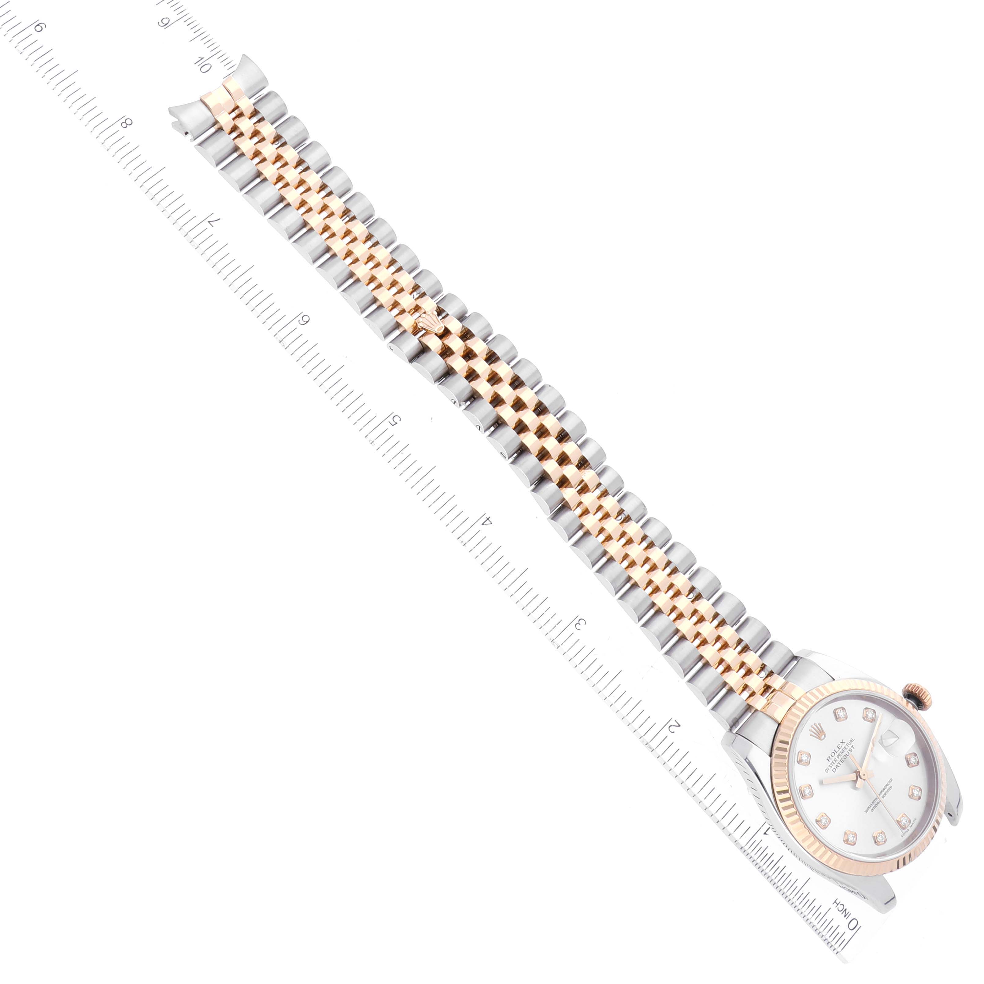 The image shows a top view of a Rolex Datejust 116233 Men's Steel and Gold (two tone) Silver Dial 116233 Men's Steel and Gold (two tone) Silver Dial watch, displaying the face and the entire two-tone bracelet against a ruler.