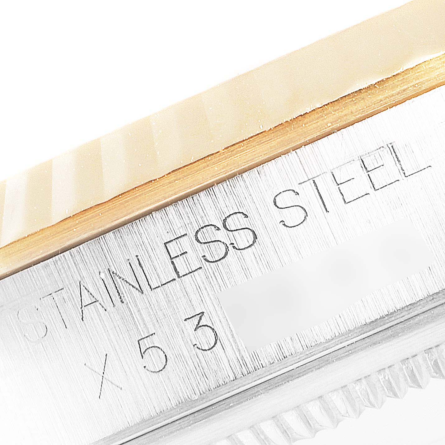 The image shows a close-up of the side of a Rolex Datejust 16233 Men
s Steel and Gold (two tone) Grey Dial 16233 Men
s Steel and Gold (two tone) Grey Dial watch, highlighting the stainless steel case with engraved text.