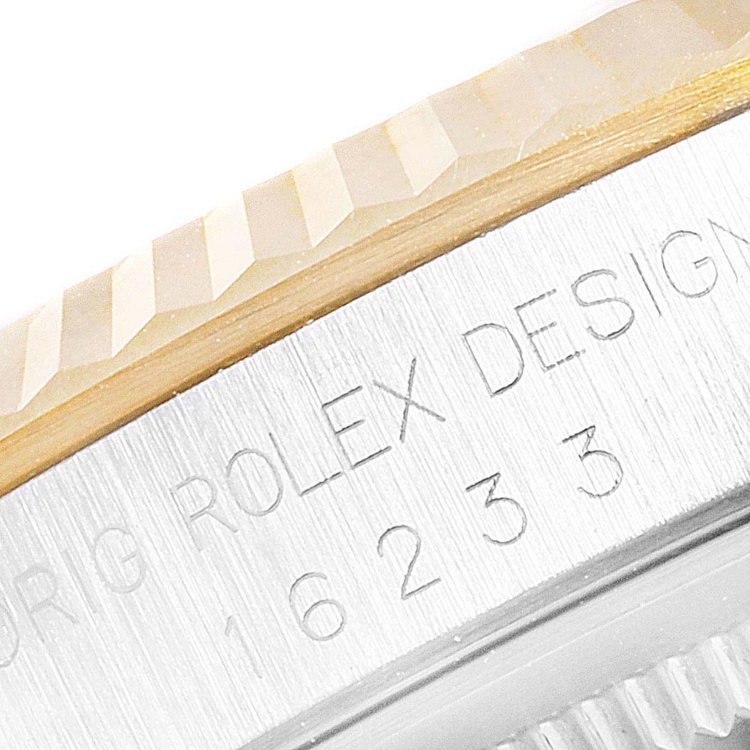 This close-up image shows the fluted bezel and engraved side of a Rolex Datejust 16233 Men
s Steel and Gold (two tone) Grey Dial 16233 Men
s Steel and Gold (two tone) Grey Dial model, featuring the model number 16233.