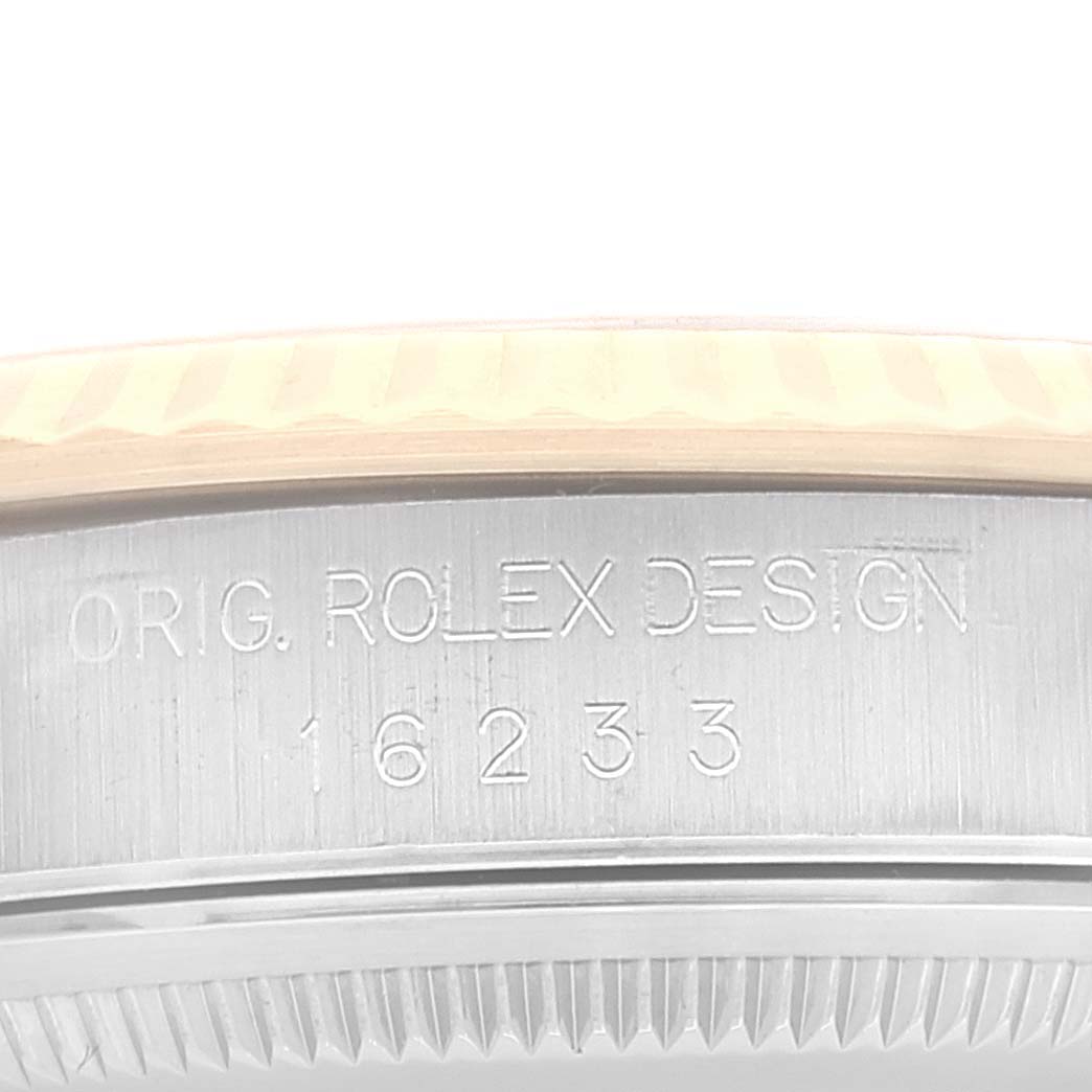 This close-up photo shows the side view of a Rolex Datejust 16233 Men
s Steel and Gold (two tone) Grey Dial 16233 Men
s Steel and Gold (two tone) Grey Dial model, displaying the engraved case back with the model number 16233.