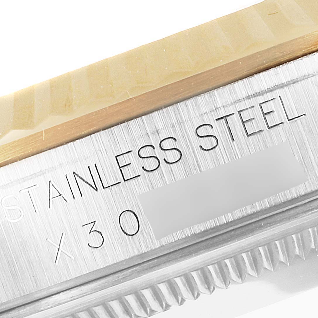 This image shows a close-up of the engraving on the side of a stainless steel Rolex Datejust 16233 Men's Steel and Gold (two tone) White Dial 16233 Men's Steel and Gold (two tone) White Dial watch case.