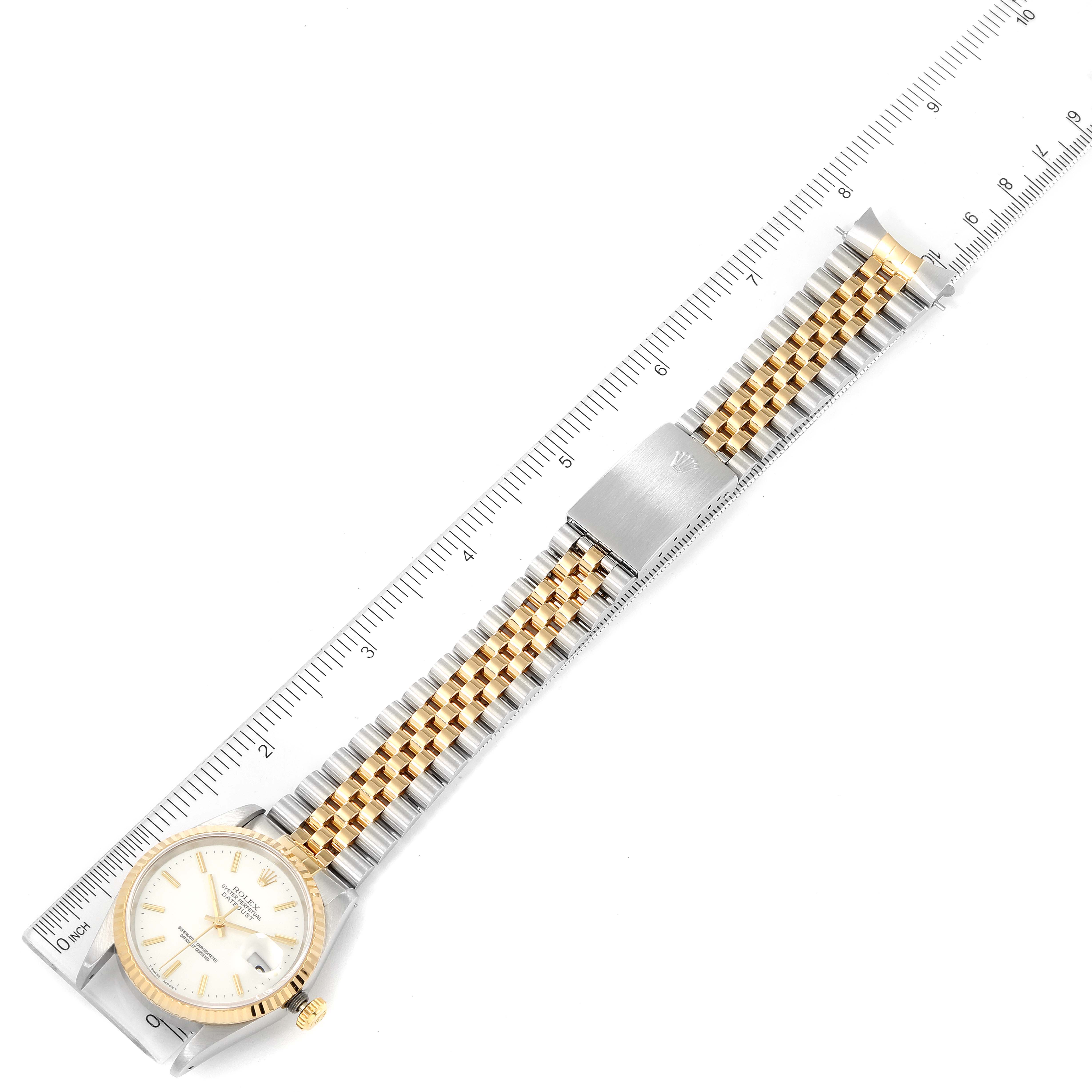 The image shows a Rolex Datejust 16233 Men's Steel and Gold (two tone) White Dial 16233 Men's Steel and Gold (two tone) White Dial watch laid flat with its bracelet extended and measured against a ruler.