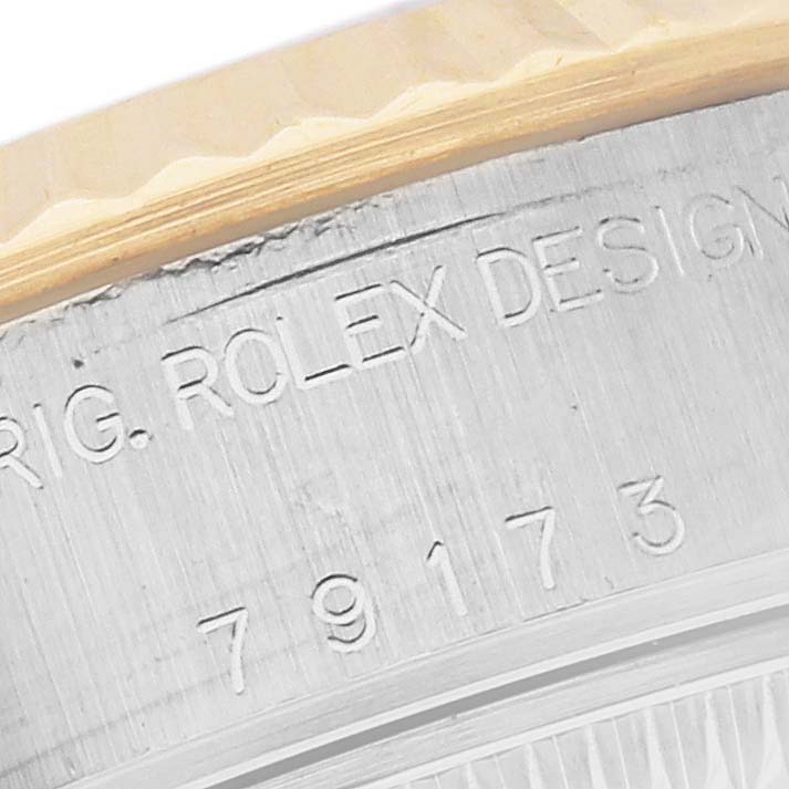 This close-up image shows the engraved serial numbers and text on the case side of a Rolex Datejust 79173 Women's Steel and Gold (two tone) White Dial 79173 Women's Steel and Gold (two tone) White Dial watch.