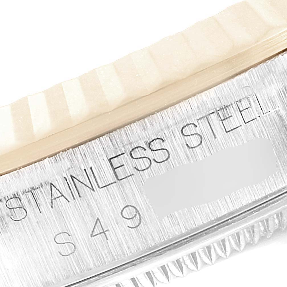 This image shows a close-up of the flank, bezel serration, and engraving on the case side of a Rolex Datejust 16233 Men's Steel and Gold (two tone) White Dial 16233 Men's Steel and Gold (two tone) White Dial model.