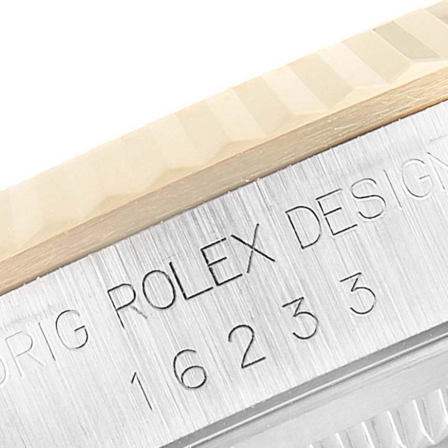 A close-up of the bezel and side engraving of a Rolex Datejust 16233 Men's Steel and Gold (two tone) White Dial 16233 Men's Steel and Gold (two tone) White Dial watch, displaying the model number 16233.