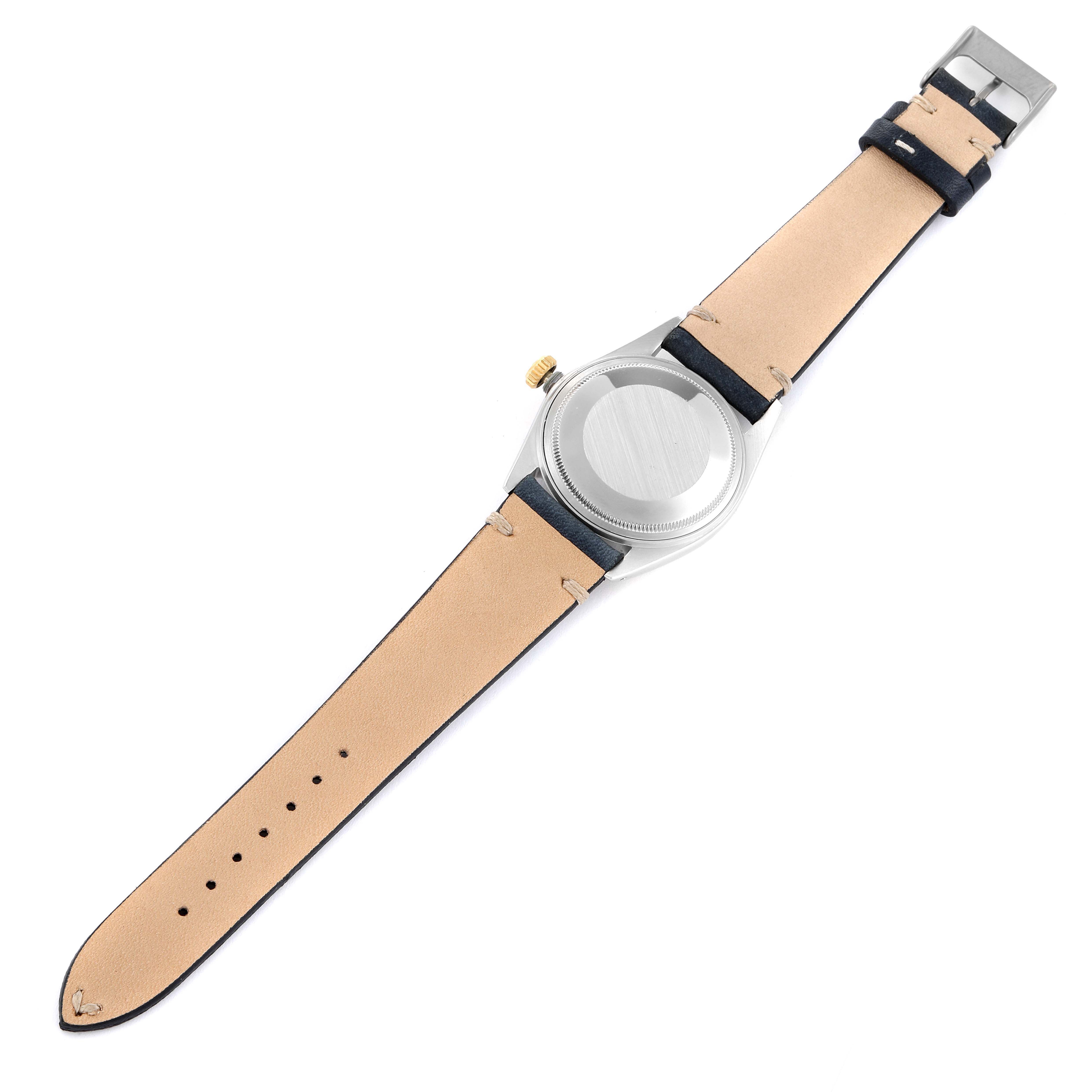 The image shows the back view of a Rolex Vintage Collection 16013 Men's Steel and Gold (two tone) White Dial 16013 Men's Steel and Gold (two tone) White Dial watch with its beige and black leather strap fully extended.