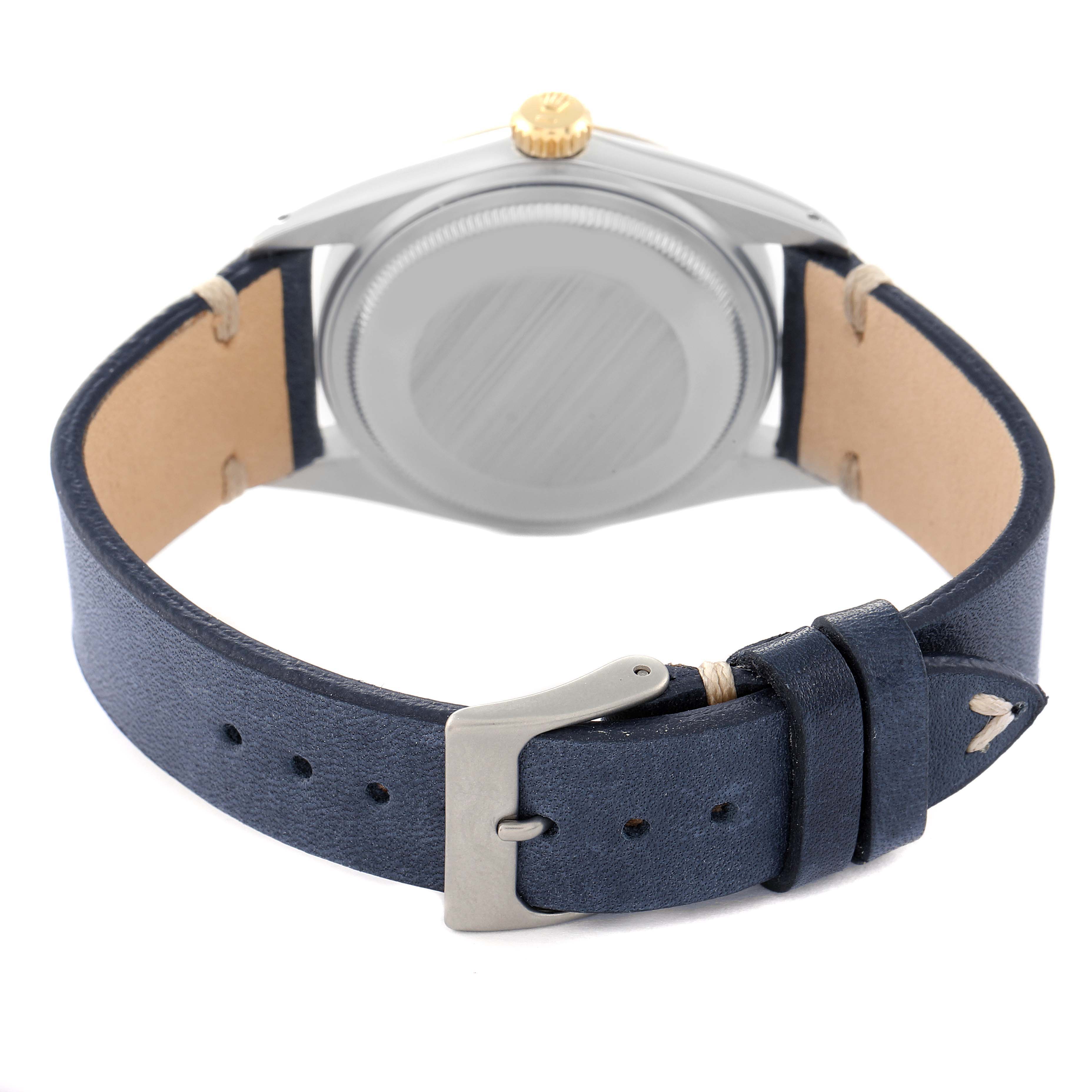 The image shows the back view of a Vintage Collection Rolex watch, highlighting its caseback, crown, and leather strap.