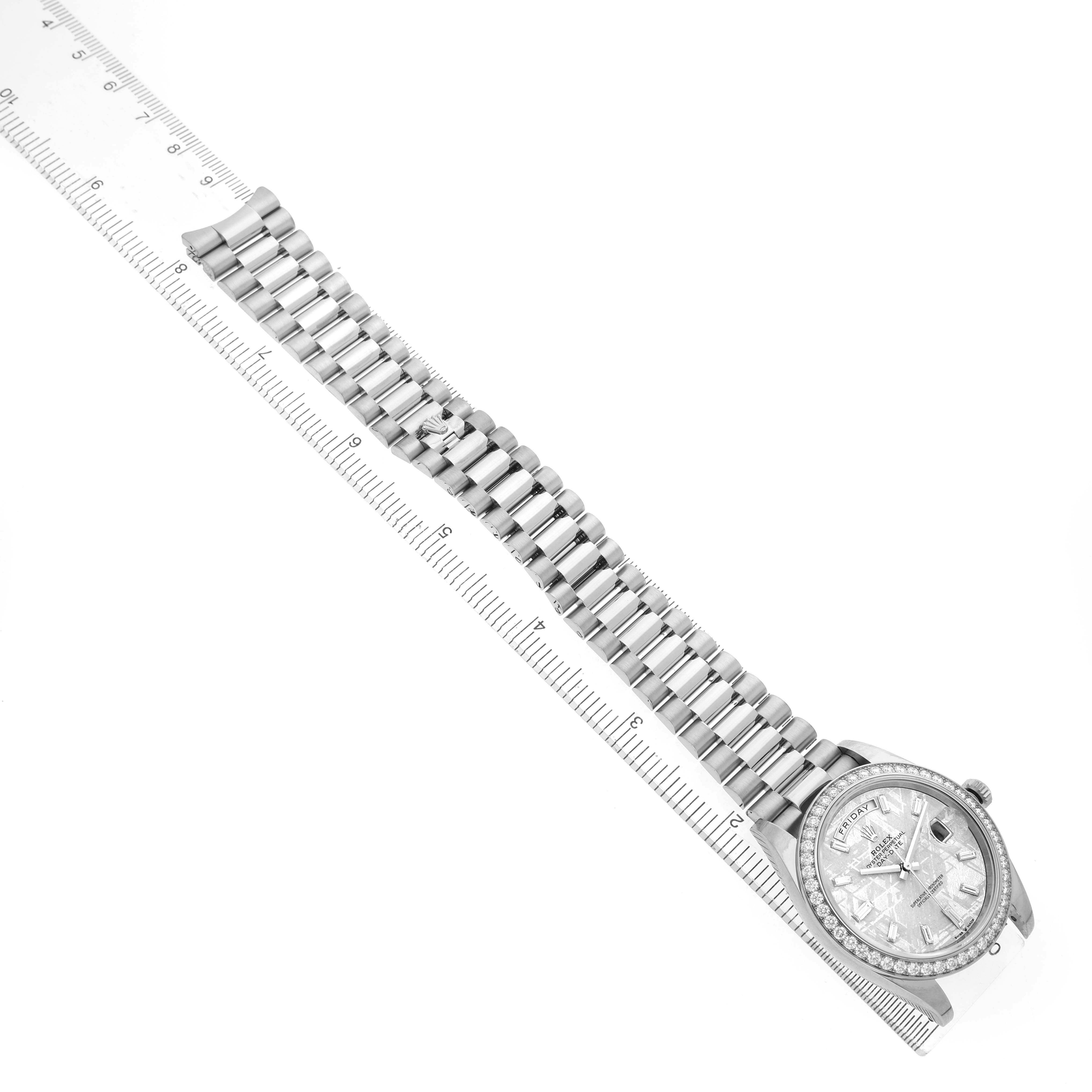 The Rolex President 228349 Men's White Gold Silver Dial watch is shown at an angle with its bracelet and face measured alongside a ruler.