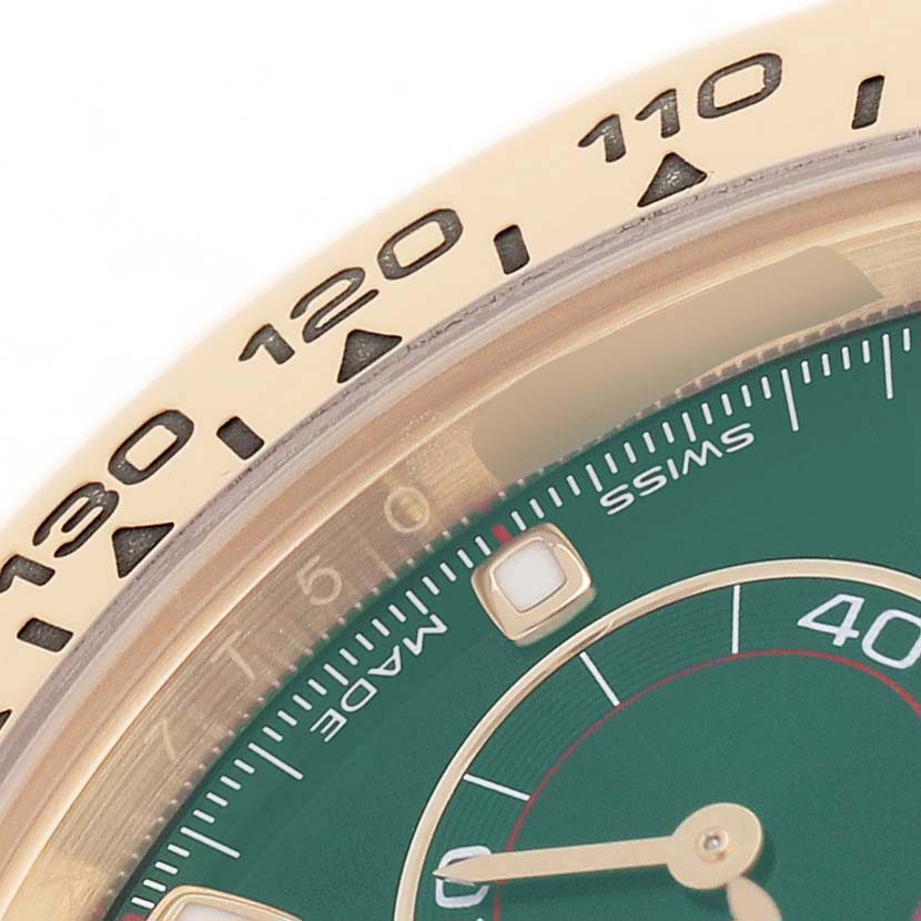The image shows a close-up of the bezel and part of the green dial of a Rolex Daytona 116508 Men's Yellow Gold Green Dial watch, with the tachymetric scale visible.