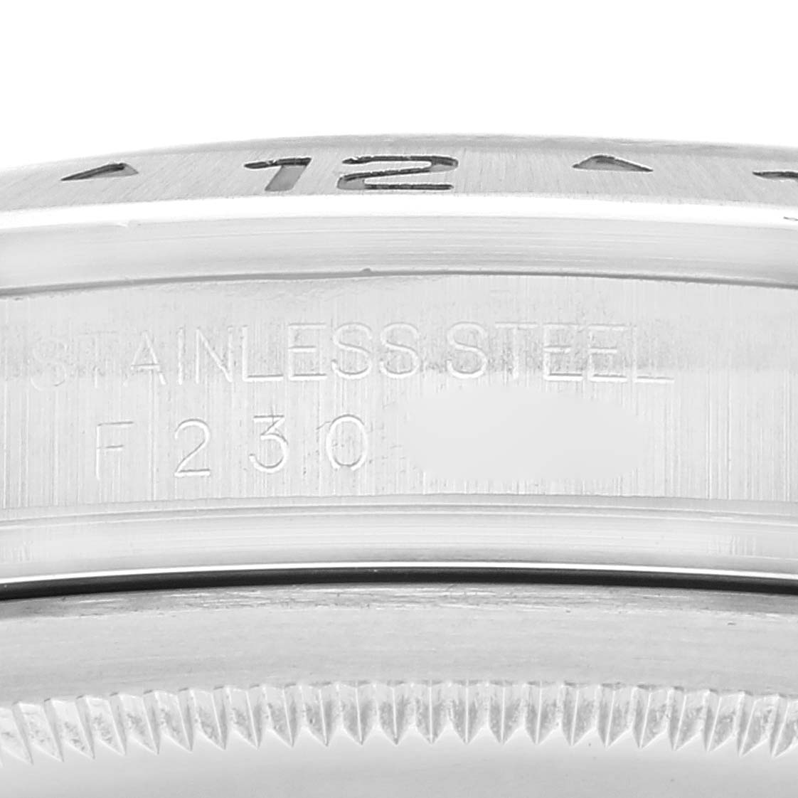 The image shows a close-up view of the side and serial number engravings of a Rolex Explorer 16570 Men's Stainless Steel White Dial 16570 Men's Stainless Steel White Dial watch.