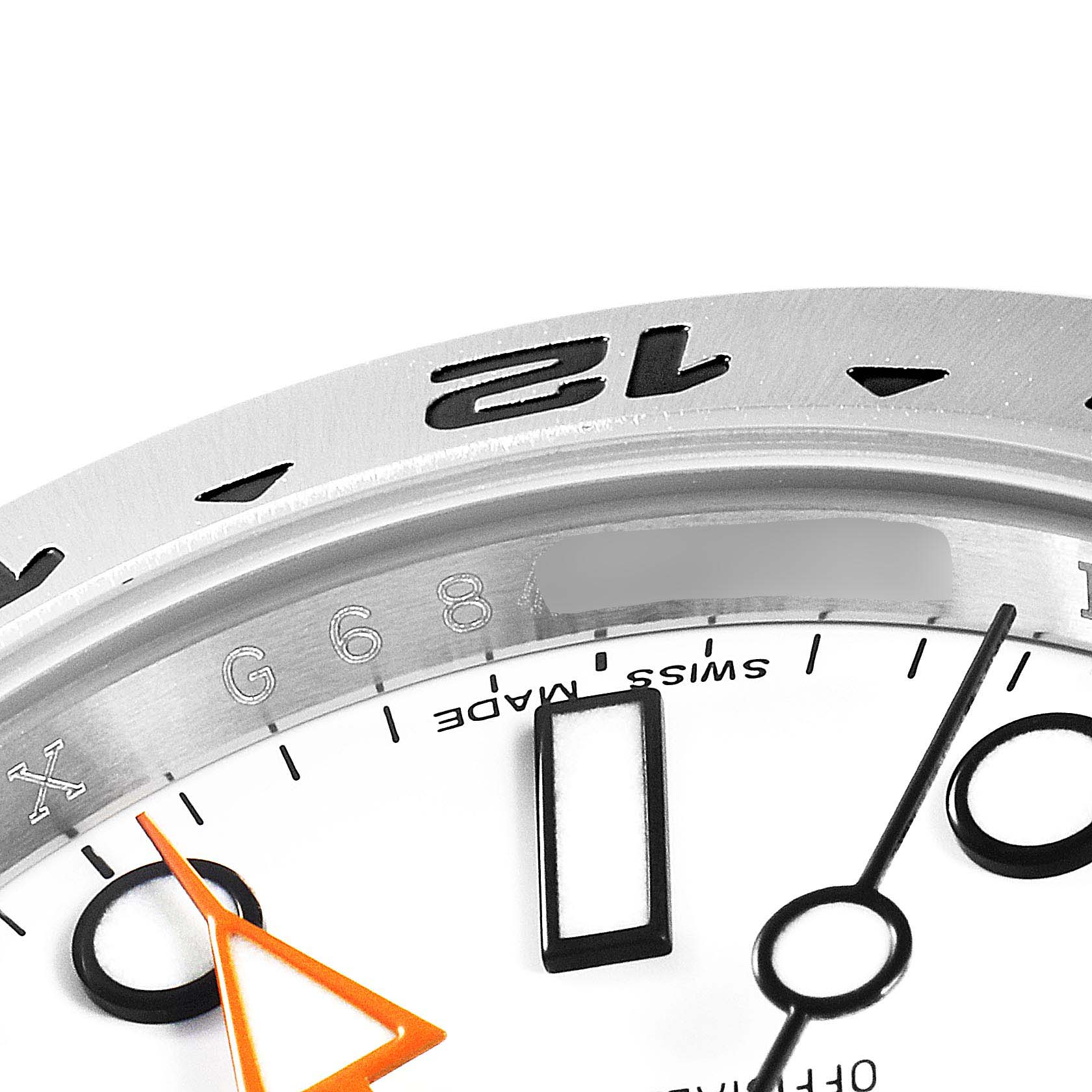 The image shows a close-up of the dial and bezel of a Rolex Explorer 216570 Men
s Stainless Steel White Dial 216570 Men
s Stainless Steel White Dial watch, highlighting the 12 o
clock marker and part of the orange hand.