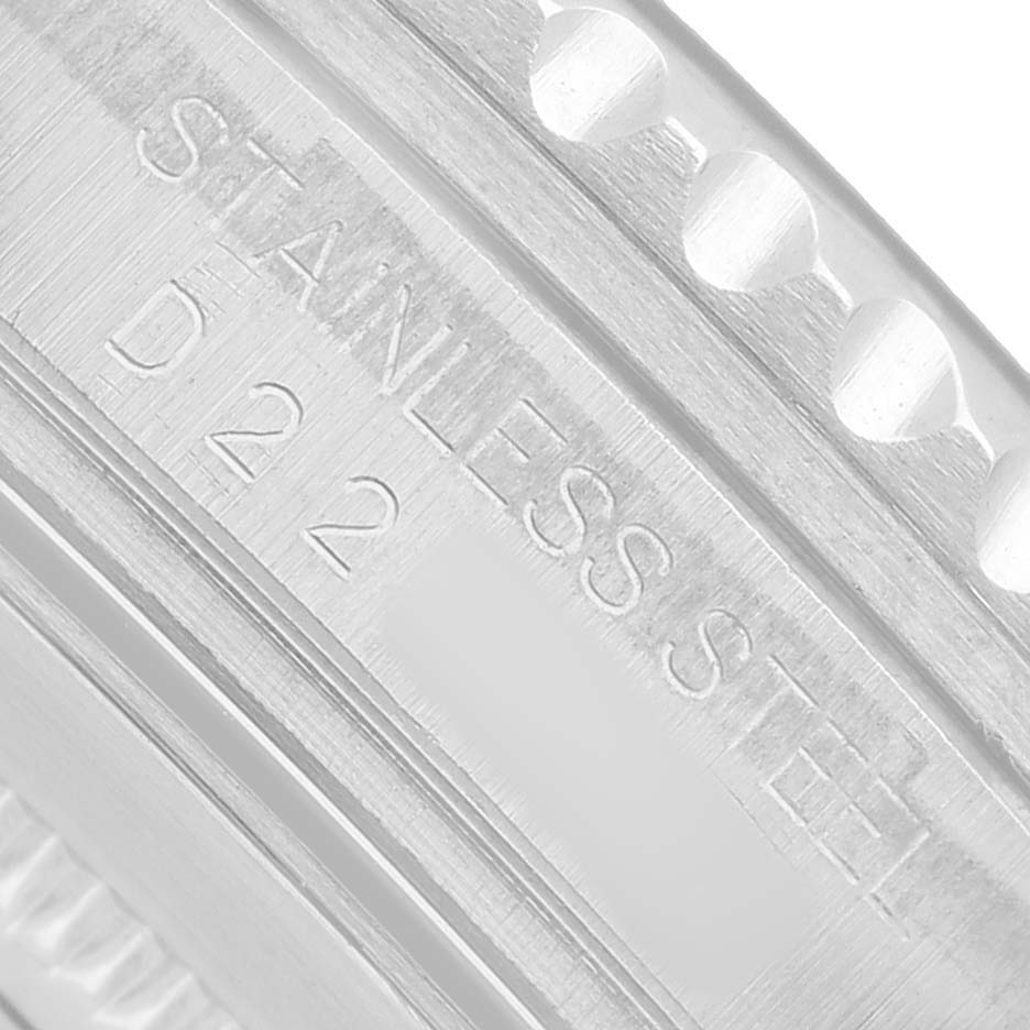 The image shows a close-up of the stainless steel bezel edge of a Rolex GMT-Master 16710 Men's Stainless Steel Black Dial watch.