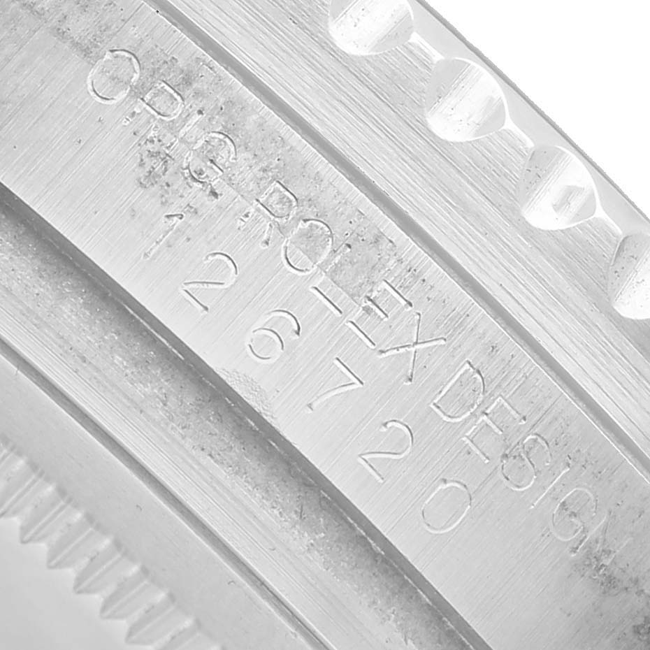 The image shows a close-up of the engraved side of the bezel on the Rolex GMT-Master 126720VTNR Men's Stainless Steel Black Dial watch, highlighting its design details.
