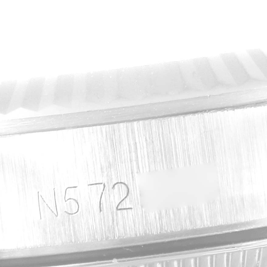 The image shows a close-up of the side of a Rolex Oyster Perpetual 67194 Women's Stainless Steel Silver Dial 67194 Women's Stainless Steel Silver Dial watch case, displaying its serial number engraving.