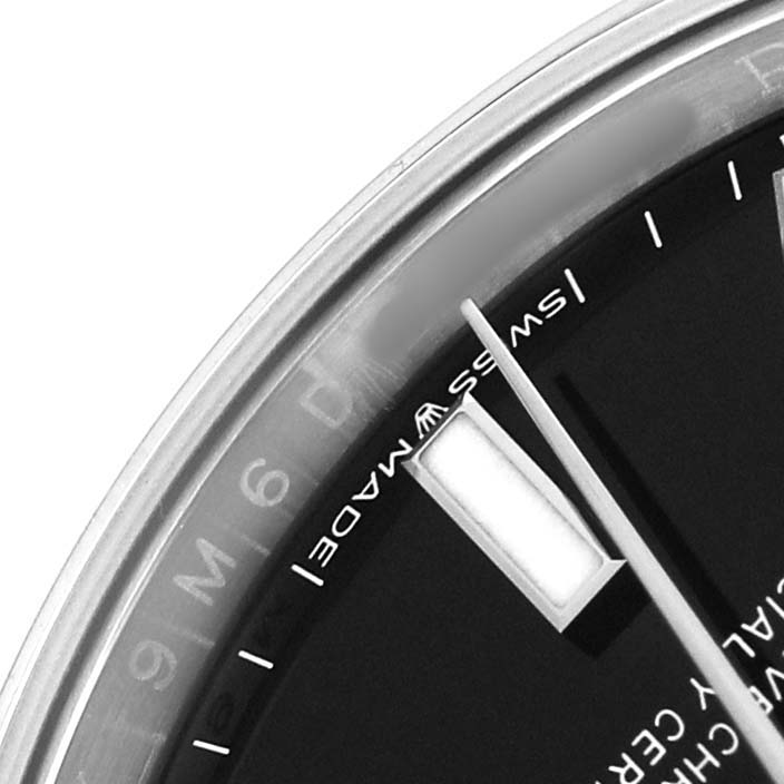 The image shows a close-up of the dial and bezel edge of a Rolex Oyster Perpetual 124200 Men's Stainless Steel Black Dial, focusing on the hour markers.