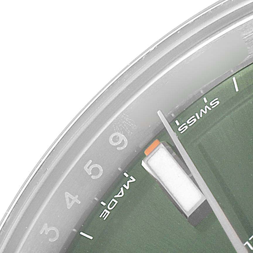 This image shows a close-up of the dial on the Rolex Oyster Perpetual 114200 Men's Stainless Steel Green Dial 114200 Men's Stainless Steel Green Dial watch, focusing on the numbers and Swiss Made text.
