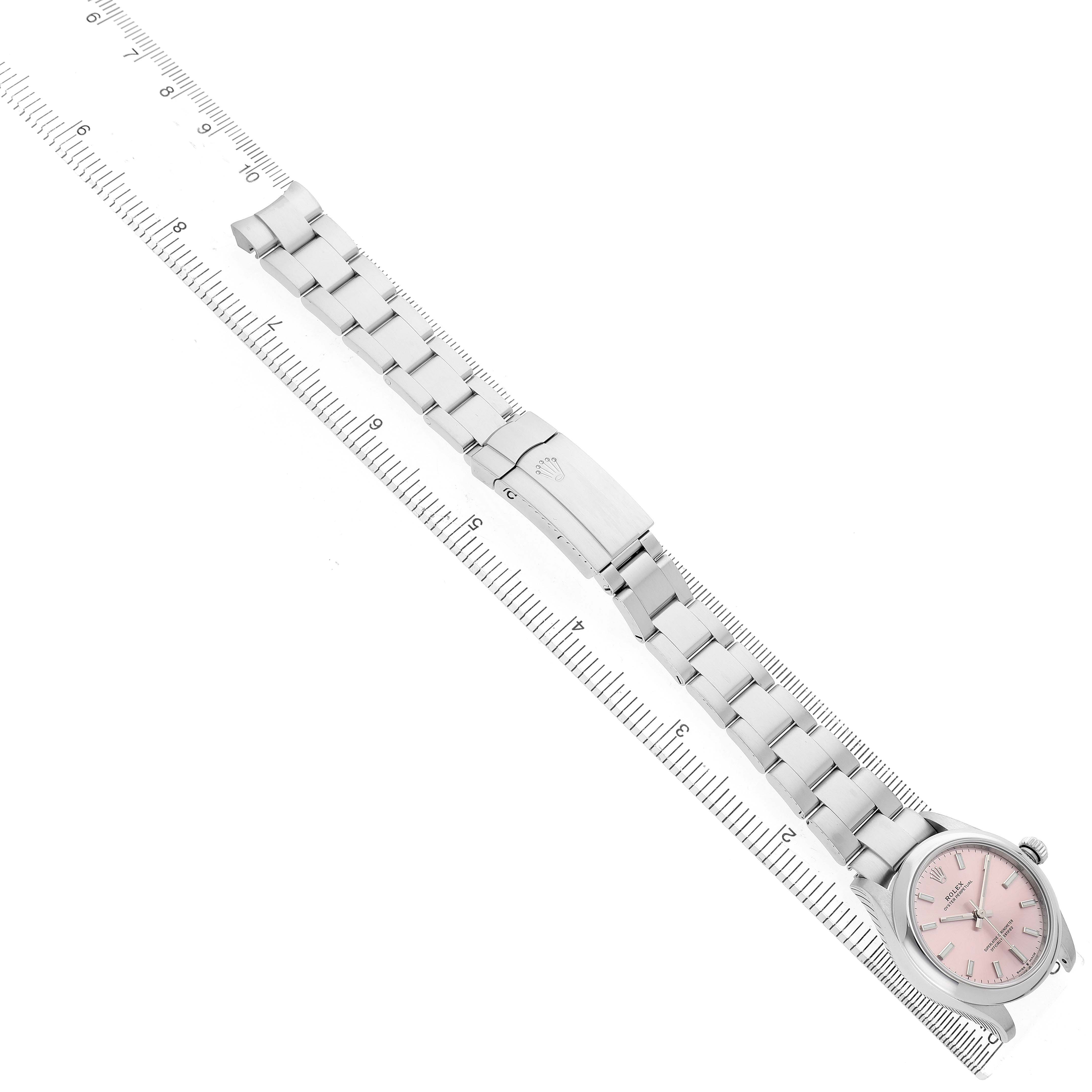 The Rolex Oyster Perpetual Women's Stainless Steel Pink Dial watch is shown from a top view, displaying the bracelet, clasp, and pink dial.