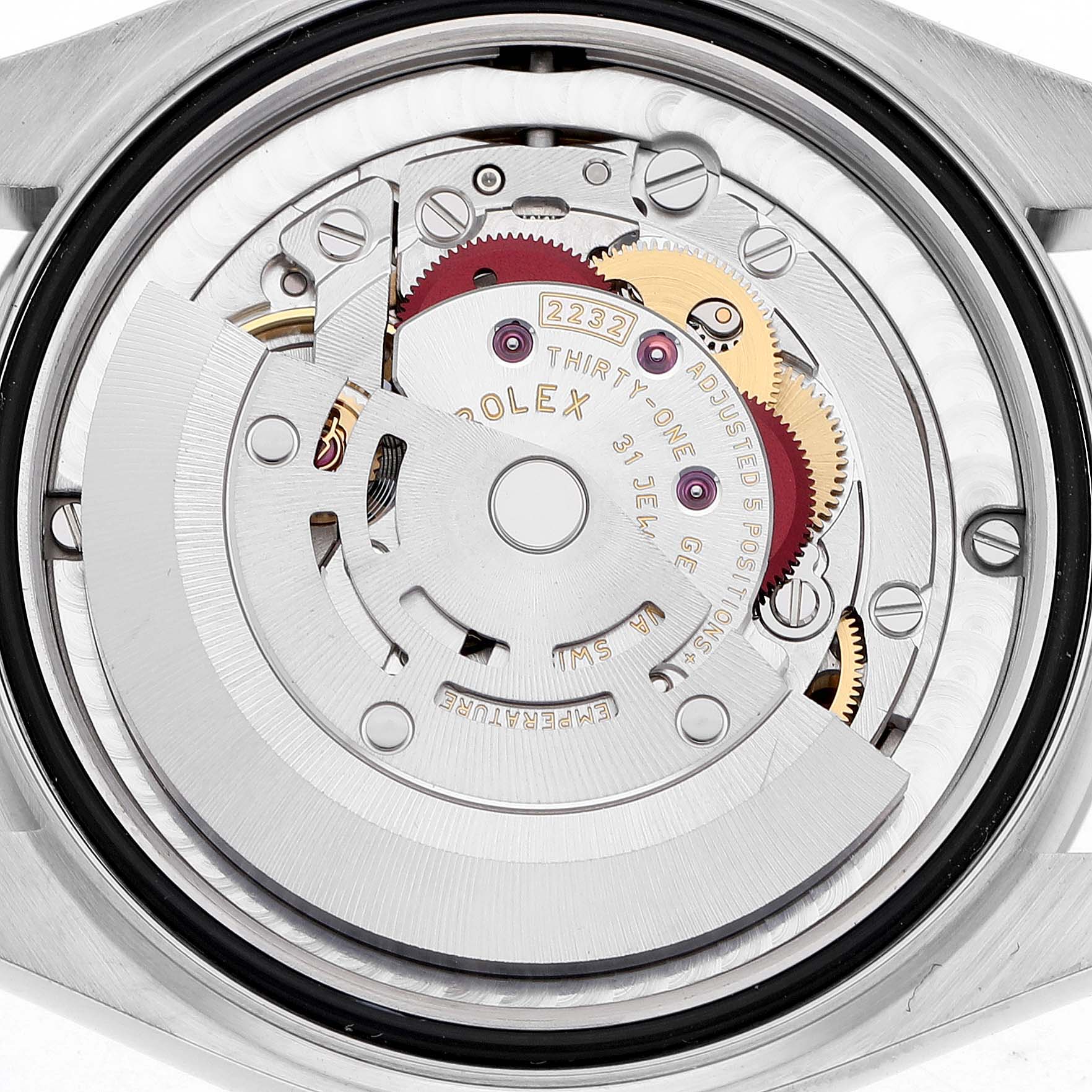 The image shows the rear angle of a Rolex Oyster Perpetual Women's Stainless Steel Pink Dial movement, highlighting gears and internal mechanics.