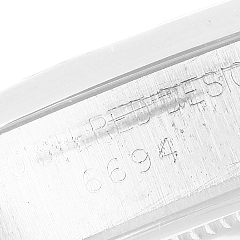 This close-up image shows the engraved serial number on the side of the casing of a Vintage Collection model by Rolex.