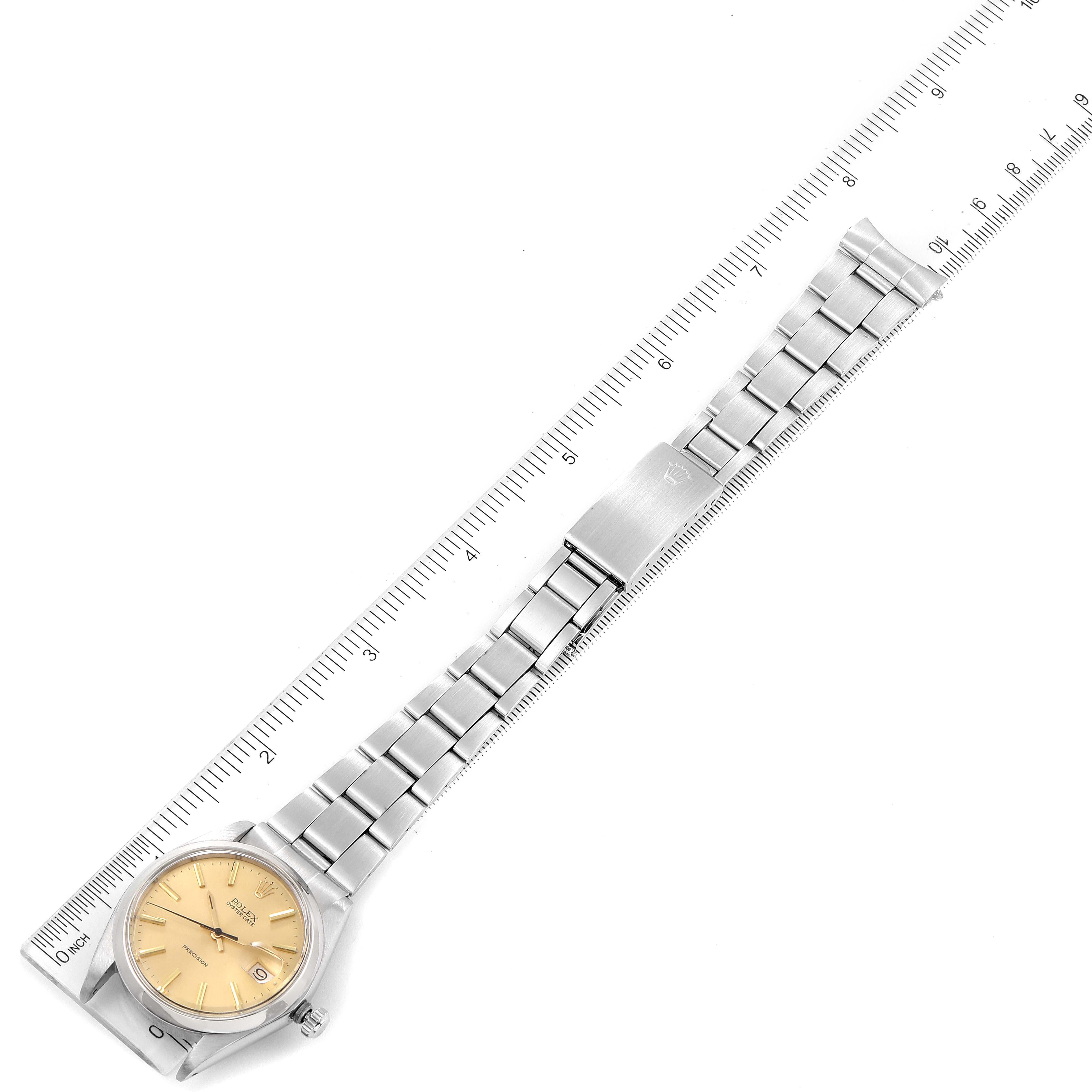 The image shows a Rolex Vintage Collection 6694 Men's Stainless Steel Champagne Dial 6694 Men's Stainless Steel Champagne Dial watch lying flat with its face, band, and clasp visible, alongside a ruler for scale.