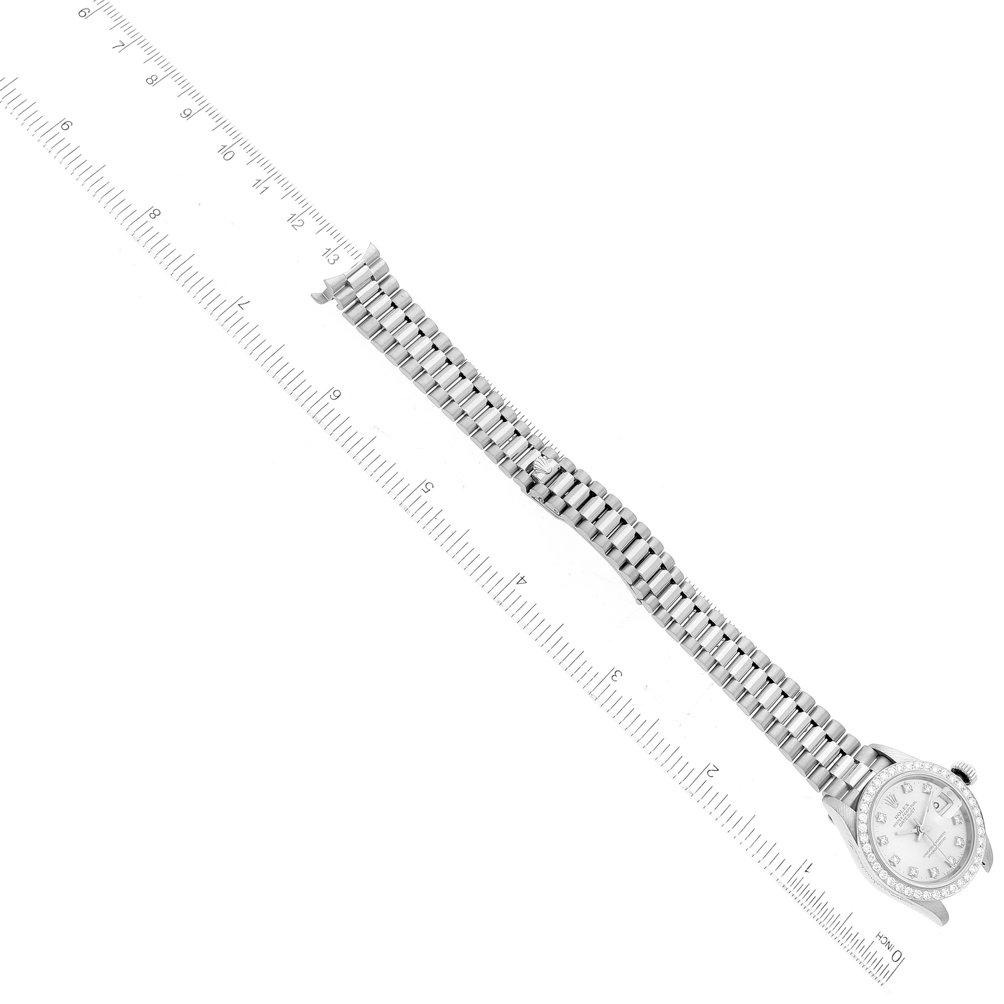 The image shows a Rolex President 69139 Women's White Gold Silver Dial 69139 Women's White Gold Silver Dial model watch in a top-down view, displaying the watch face, bracelet, and clasp with a ruler for scale.