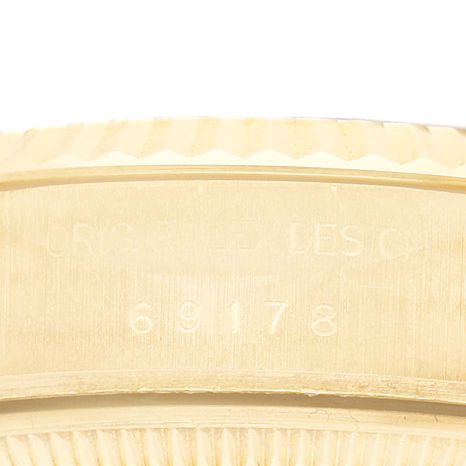 The image shows the side profile focusing on the engravings of the Rolex President 69178 Women's Yellow Gold Champagne Dial model watch.