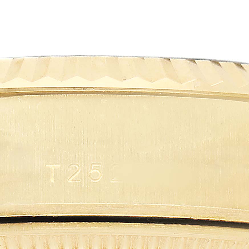 The image shows a close-up of the bezel and side case of a Rolex President 69178 Women's Yellow Gold Champagne Dial watch, featuring its characteristic fluted design.