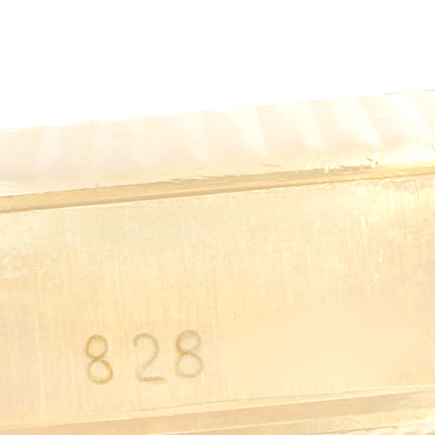 This image shows a close-up view of the clasp or bracelet link of a Rolex President 69178 Women
s Yellow Gold Silver Dial 69178 Women
s Yellow Gold Silver Dial model, featuring the number "828".