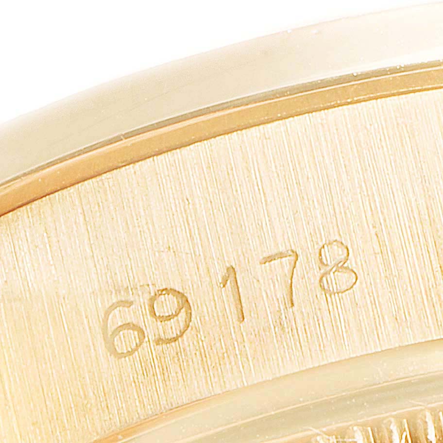 This close-up image shows the engraved outer rim of a Rolex President 69178 Women
s Yellow Gold Silver Dial 69178 Women
s Yellow Gold Silver Dial watch model 69178.