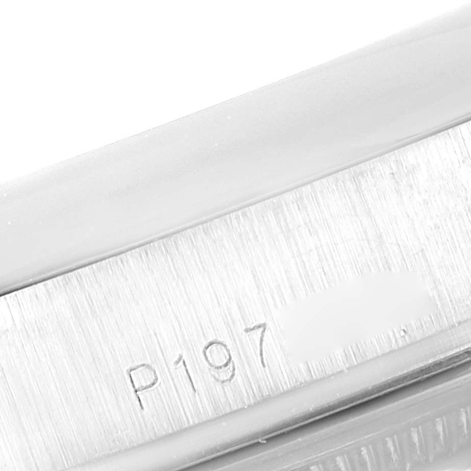 This image shows a partial view of the serial number engraved on the case of a Rolex President 118296 Men's Platinum Blue Dial 118296 Men's Platinum Blue Dial model watch.