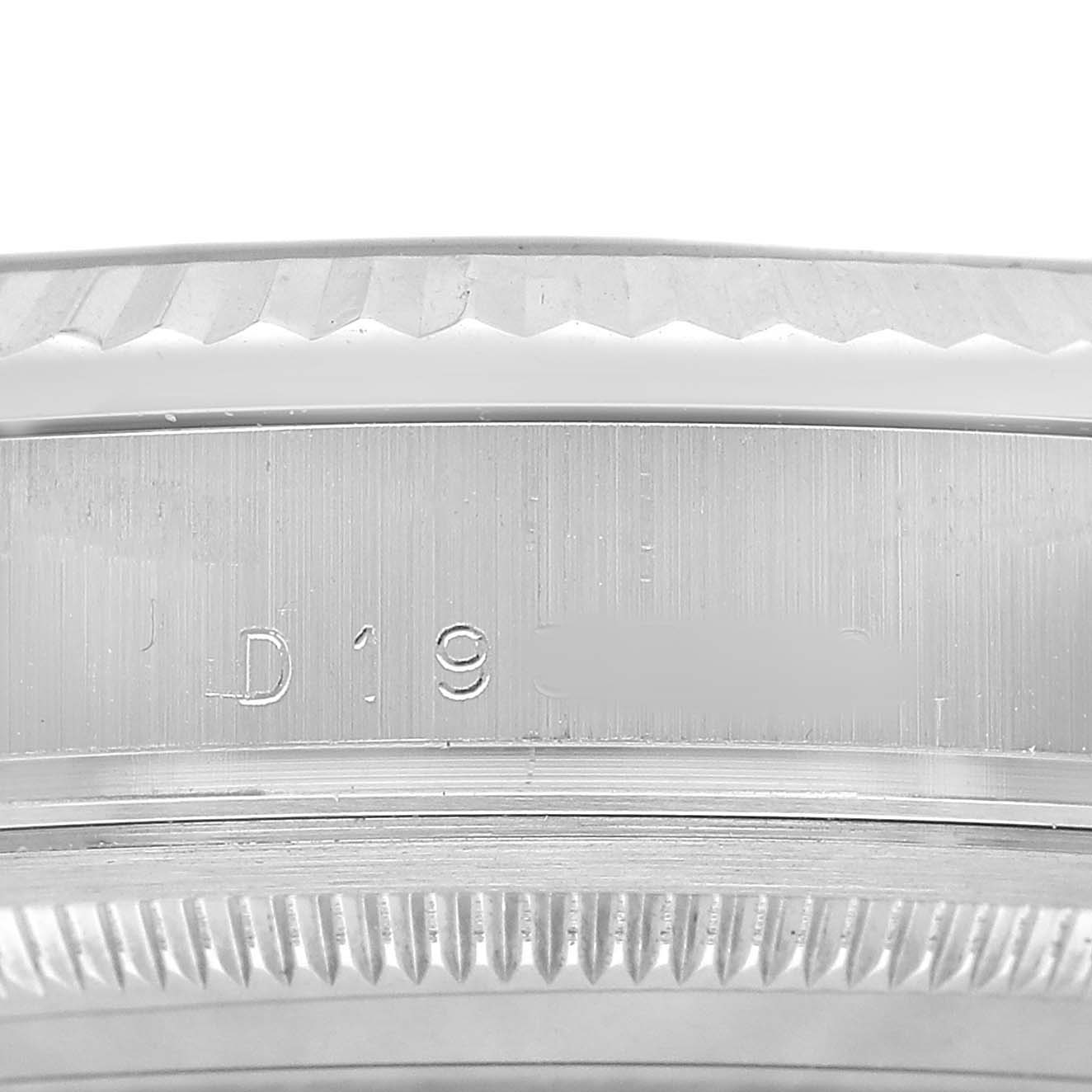 The image shows a close-up of the President model by Rolex, focusing on the case edge and serial number.