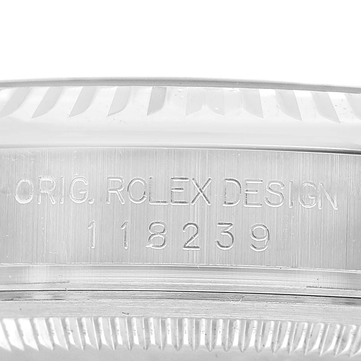 The image shows the side of the Rolex President 118239 Men's White Gold Silver Dial model, highlighting the engraving on the watch case.