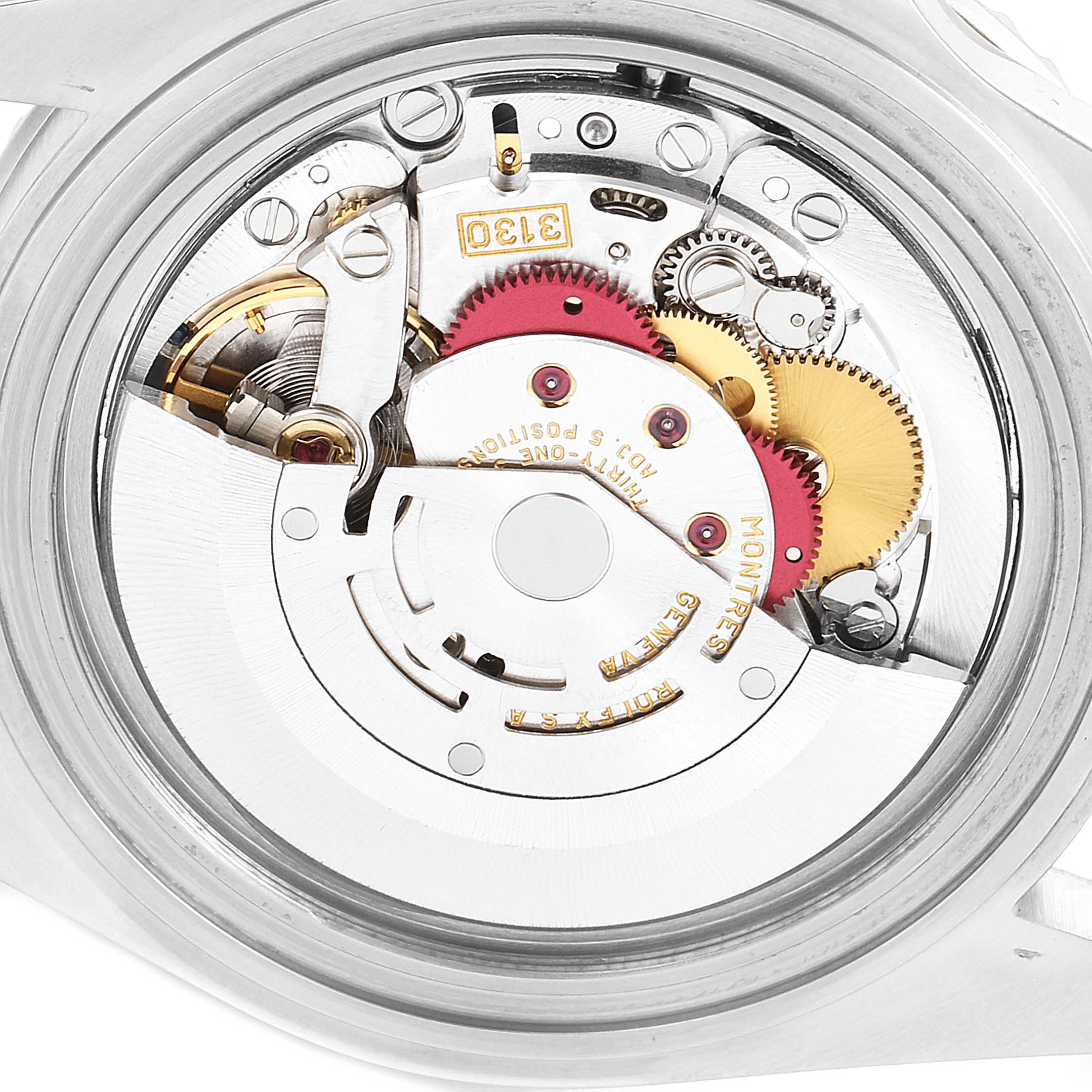 The image shows the internal mechanics of a Rolex Submariner 14060 Men
s Stainless Steel Black Dial 14060 Men
s Stainless Steel Black Dial watch, showcasing its movement components and gears.