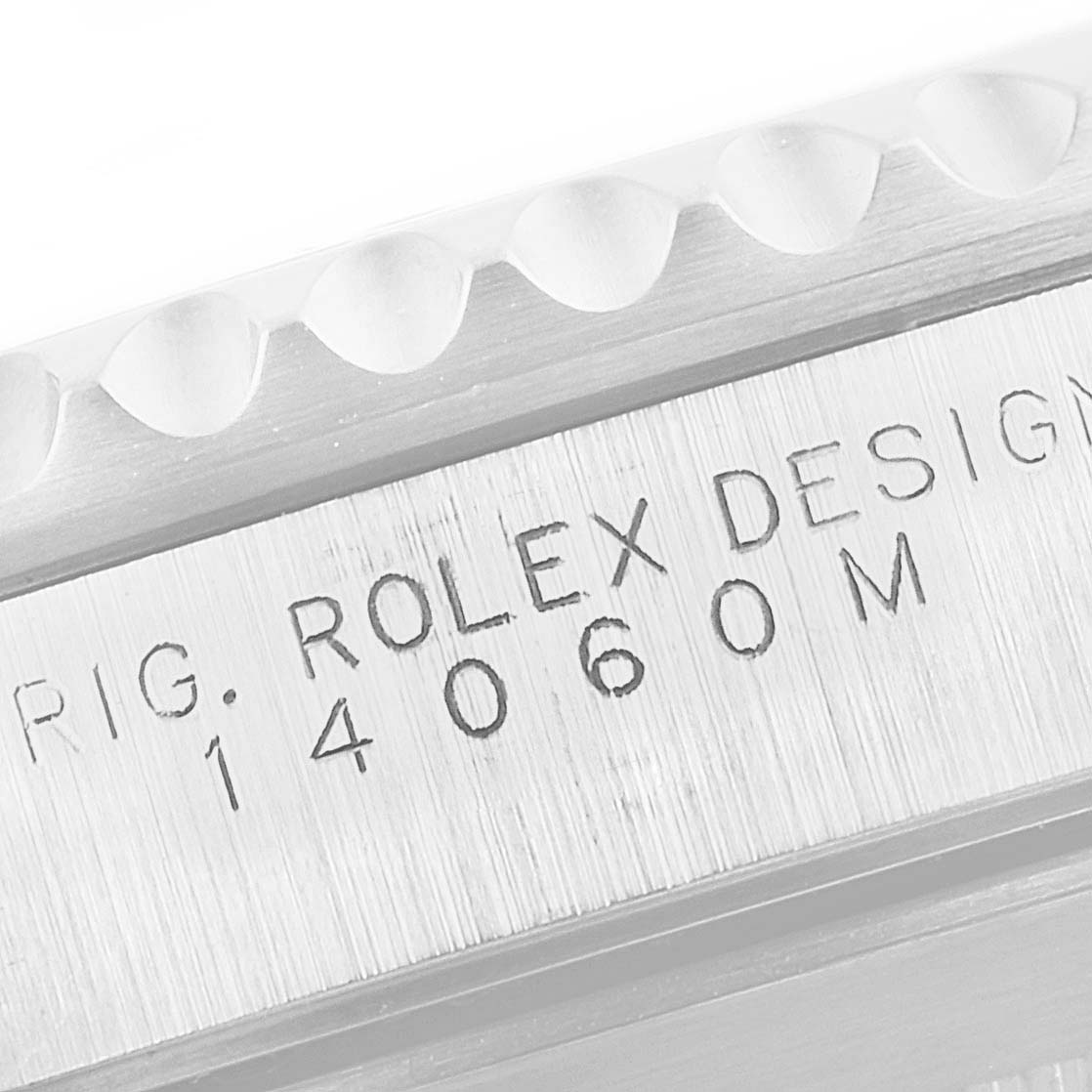 This image shows a close-up of the side of a Rolex Submariner 14060 Men
s Stainless Steel Black Dial 14060 Men
s Stainless Steel Black Dial watch, highlighting the engraved model number and design inscription.
