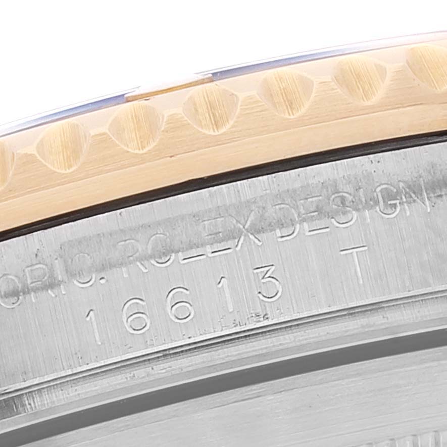 This close-up shot of the Rolex Submariner 16613 Men
s Steel and Gold (two tone) Blue Dial 16613 Men
s Steel and Gold (two tone) Blue Dial shows part of the bezel and the engraved model number.