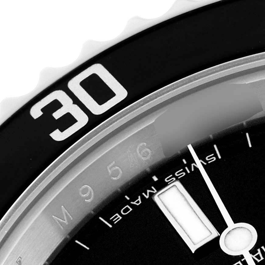 The image shows a close-up of the bezel and dial of a Rolex Submariner 14060M Men
s Stainless Steel Black Dial 14060M Men
s Stainless Steel Black Dial watch, focusing on the 30-minute mark and part of the "SWISS MADE" text.