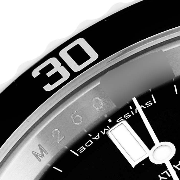 The close-up image of this Rolex Submariner 14060M Men
s Stainless Steel Black Dial 14060M Men
s Stainless Steel Black Dial watch shows part of the bezel and the minute hand.