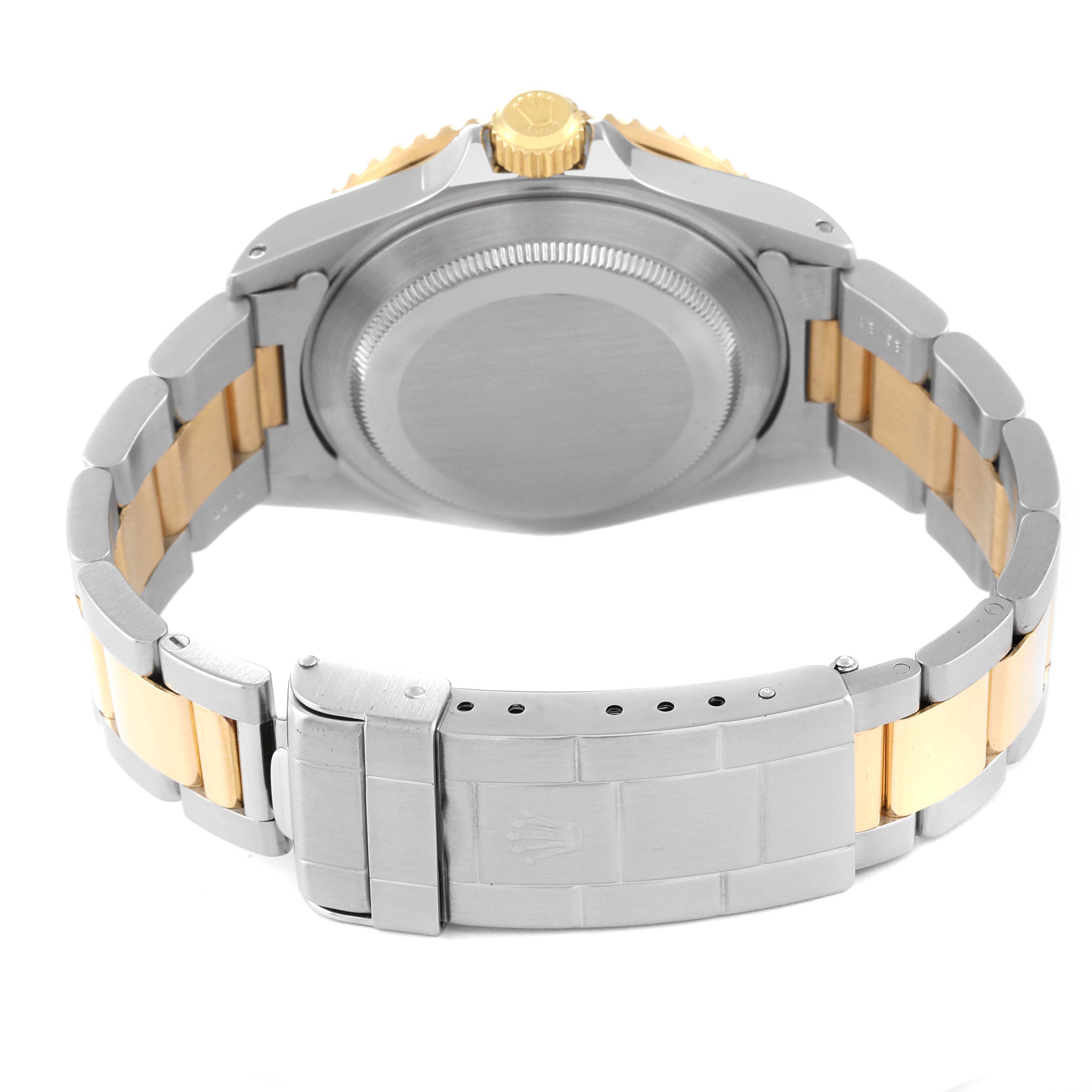 The image shows a rear view of a Rolex Submariner 16613 Men
s Steel and Gold (two tone) Black Dial 16613 Men
s Steel and Gold (two tone) Black Dial watch, displaying its bracelet and case back.