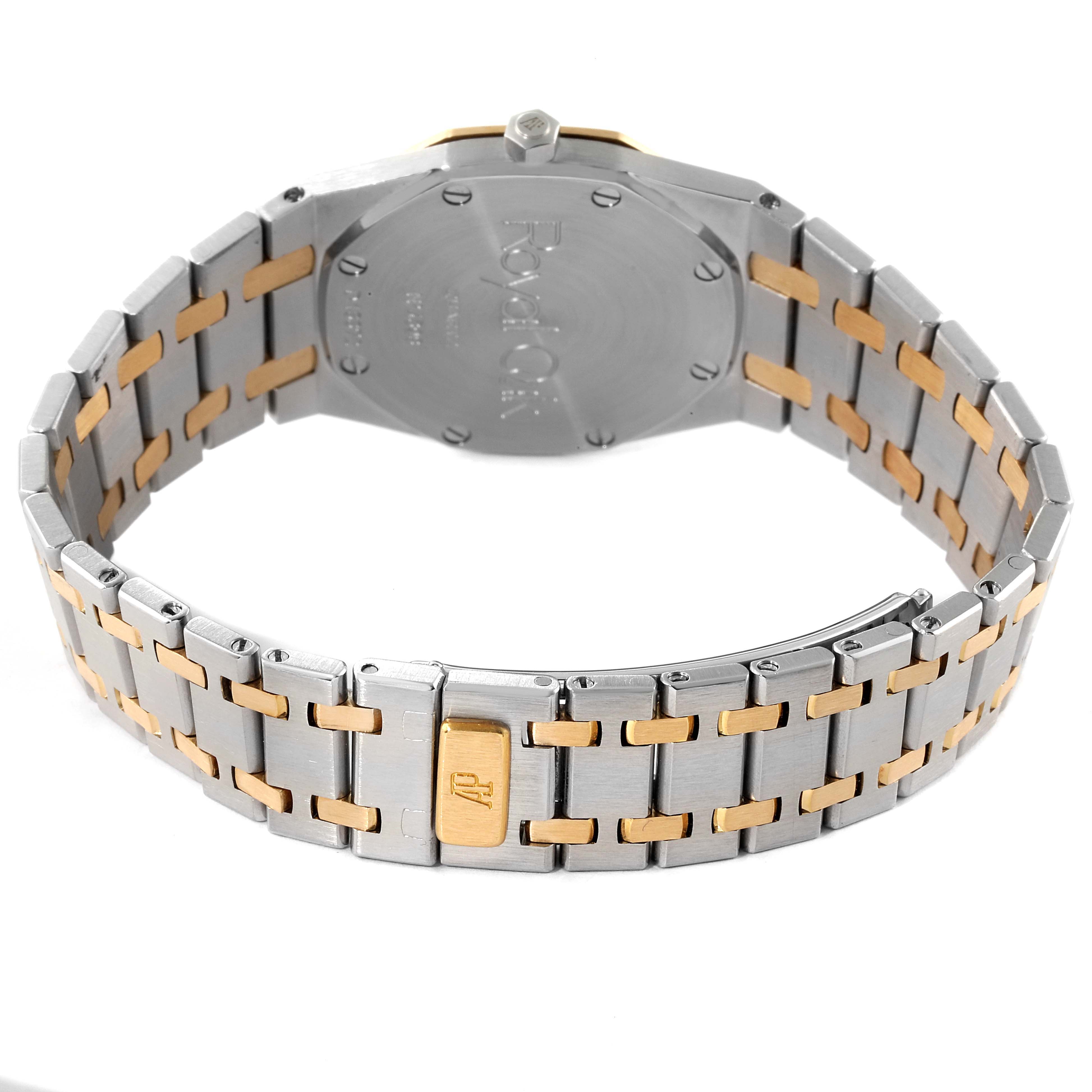 The image shows the case back and bracelet of an Audemars Piguet Royal Oak 56303SA Men
s Steel and Gold (two tone) Grey Dial 56303SA Men
s Steel and Gold (two tone) Grey Dial watch from a rear angle.