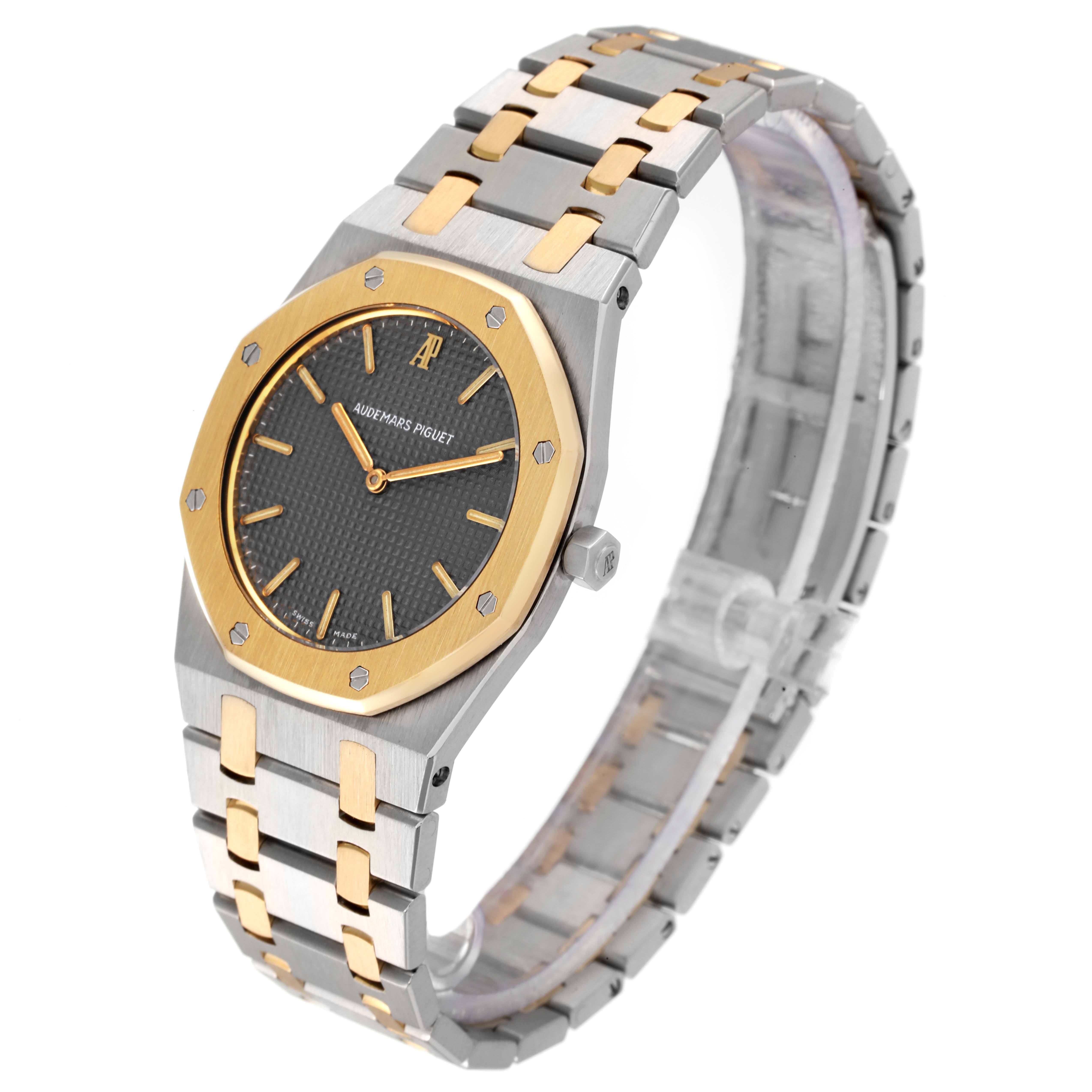 This image shows a side angle of an Audemars Piguet Royal Oak 56303SA Men
s Steel and Gold (two tone) Grey Dial 56303SA Men
s Steel and Gold (two tone) Grey Dial watch, displaying the dial, bezel, case, bracelet, and crown.