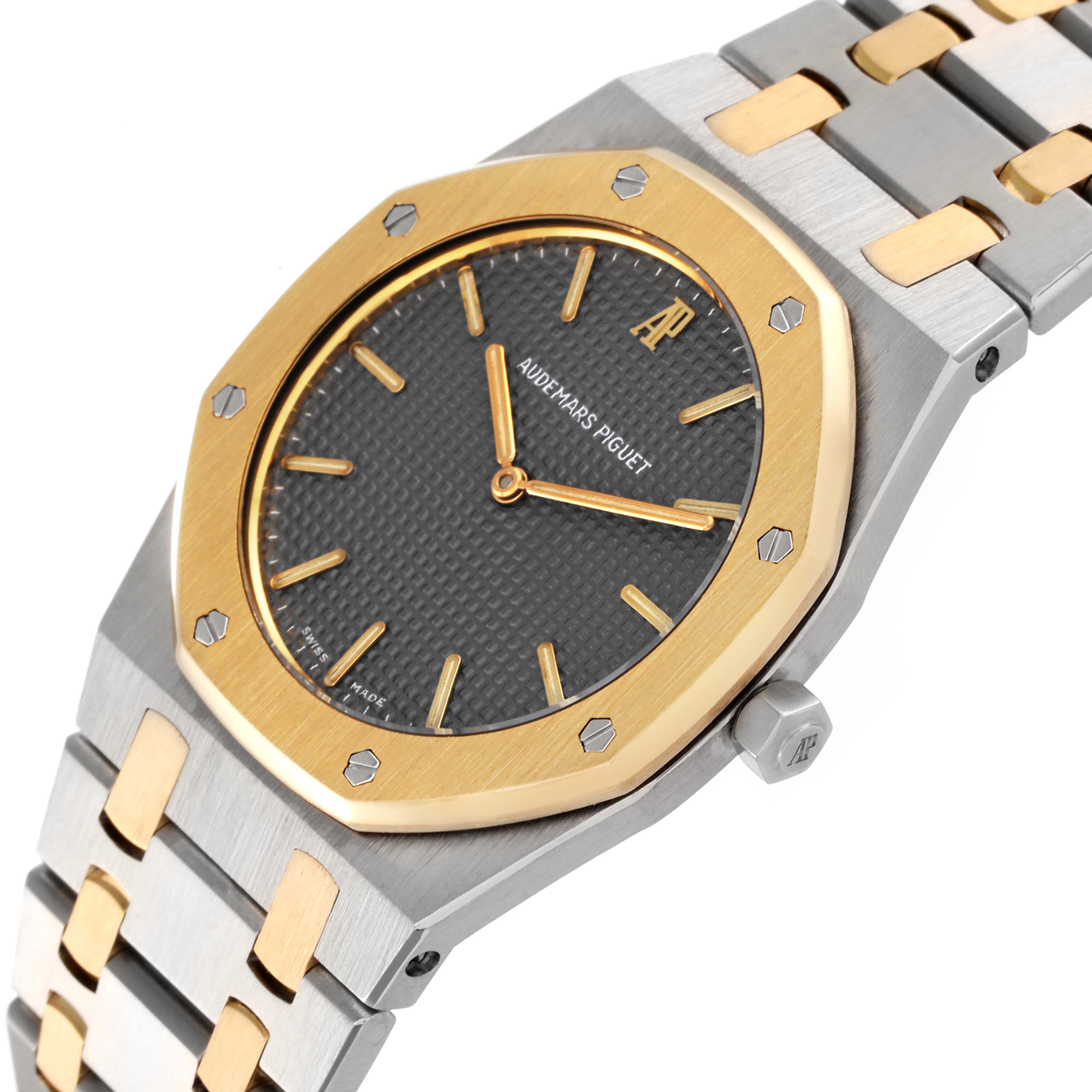 The image shows a close-up angle of the dial, bezel, and part of the bracelet of the Audemars Piguet Royal Oak 56303SA Men
s Steel and Gold (two tone) Grey Dial 56303SA Men
s Steel and Gold (two tone) Grey Dial watch.
