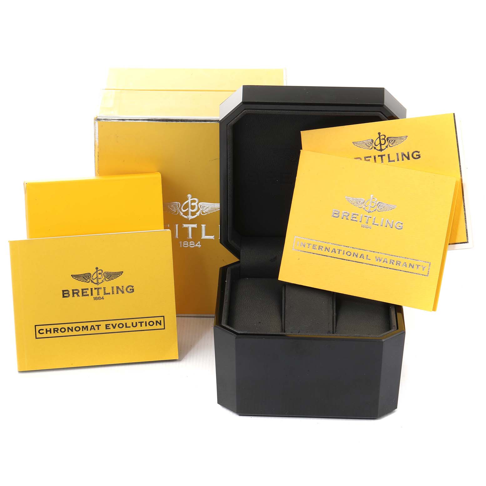 This image shows a Breitling Chronomat A13356 Men's Stainless Steel Grey Dial A13356 Men's Stainless Steel Grey Dial watch box, its packaging, and accompanying booklets, including a warranty and model guide.