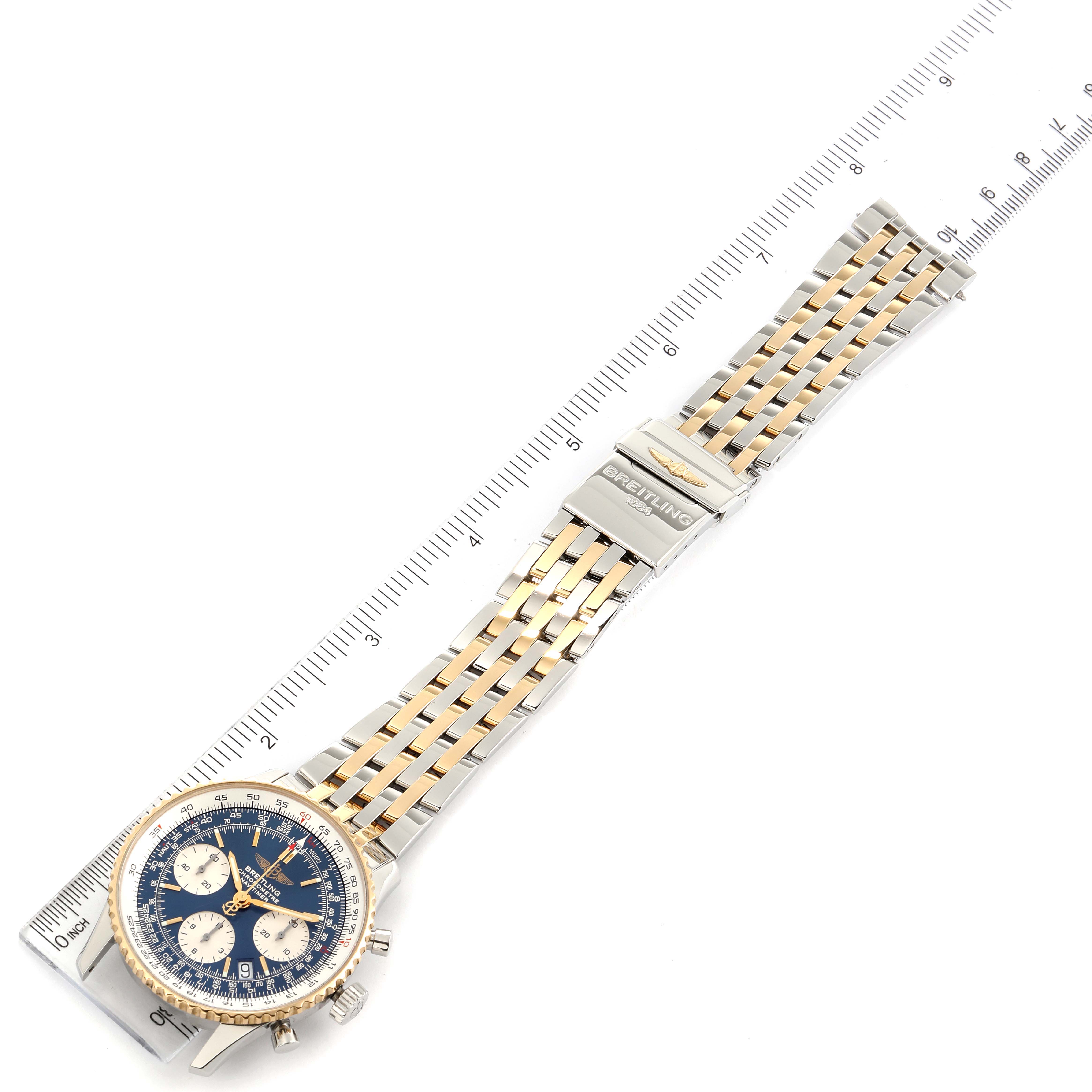 The image shows a top-down view of a Breitling Navitimer D23322 Men's Steel and Gold (two tone) Blue Dial D23322 Men's Steel and Gold (two tone) Blue Dial watch, highlighting its two-tone bracelet, dial, and clasp.