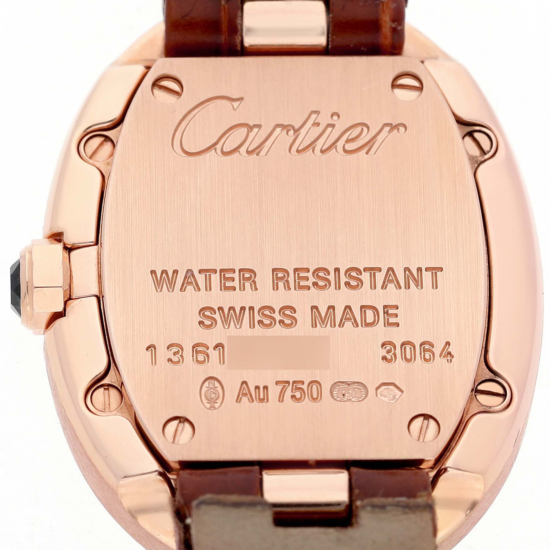 The image shows the back case of a Cartier Baignoire W8000007 Women's Rose Gold Silver Dial watch, highlighting its metal finish and engraved details.
