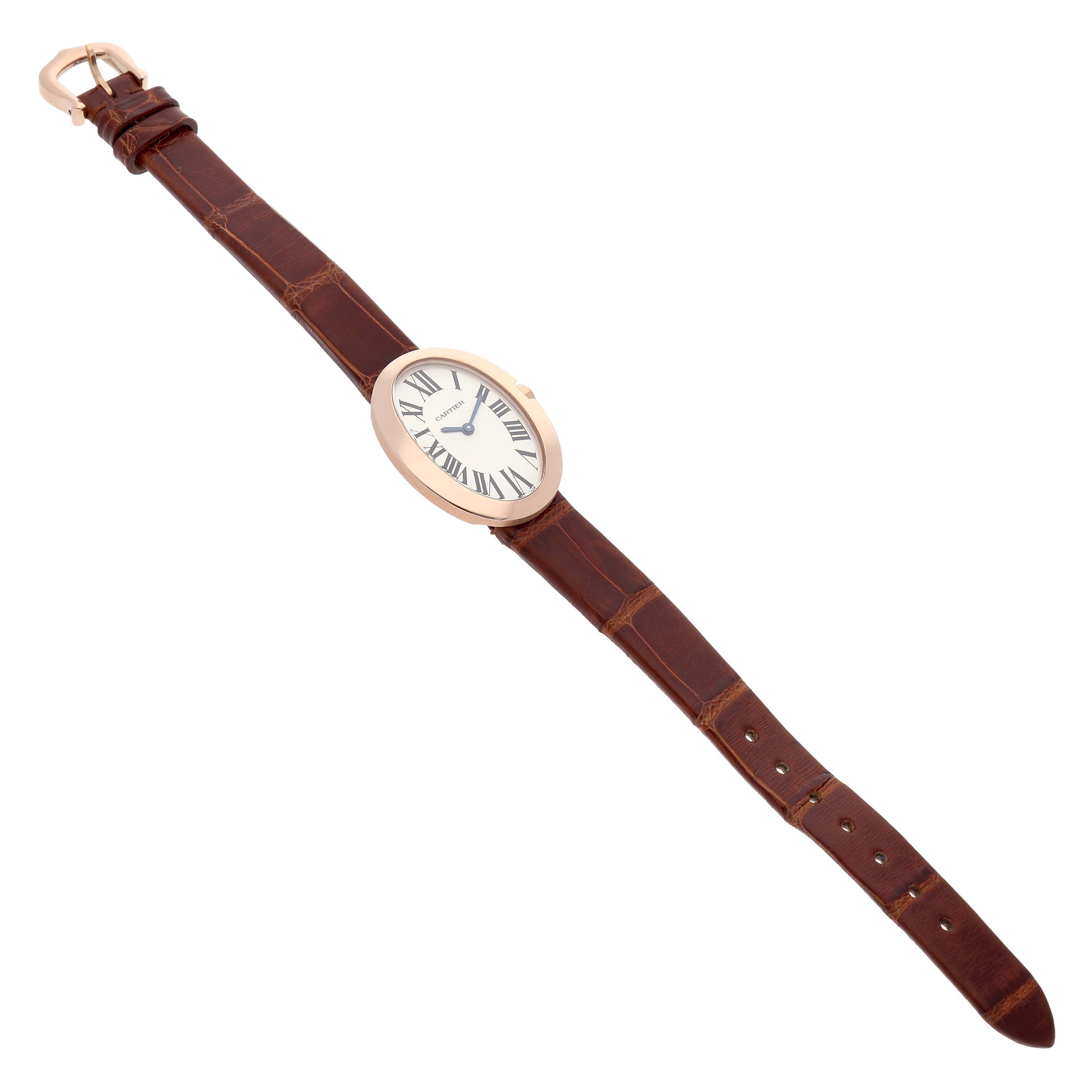The Cartier Baignoire W8000007 Women's Rose Gold Silver Dial watch is shown flat from an overhead angle, highlighting the face and brown leather strap.