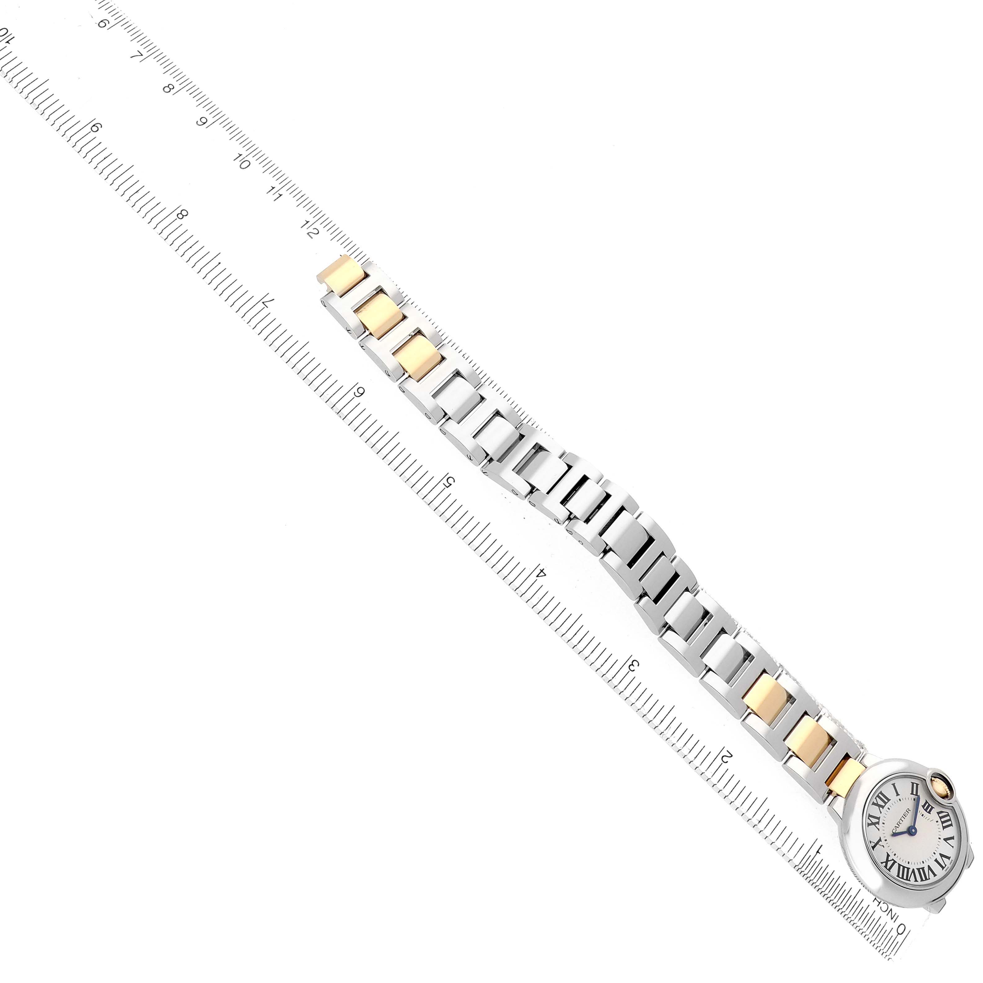 The Cartier Ballon Bleu W69007Z3 Women's Stainless Steel Silver Dial watch is shown from a top view, displaying the full bracelet and face aligned with a ruler.