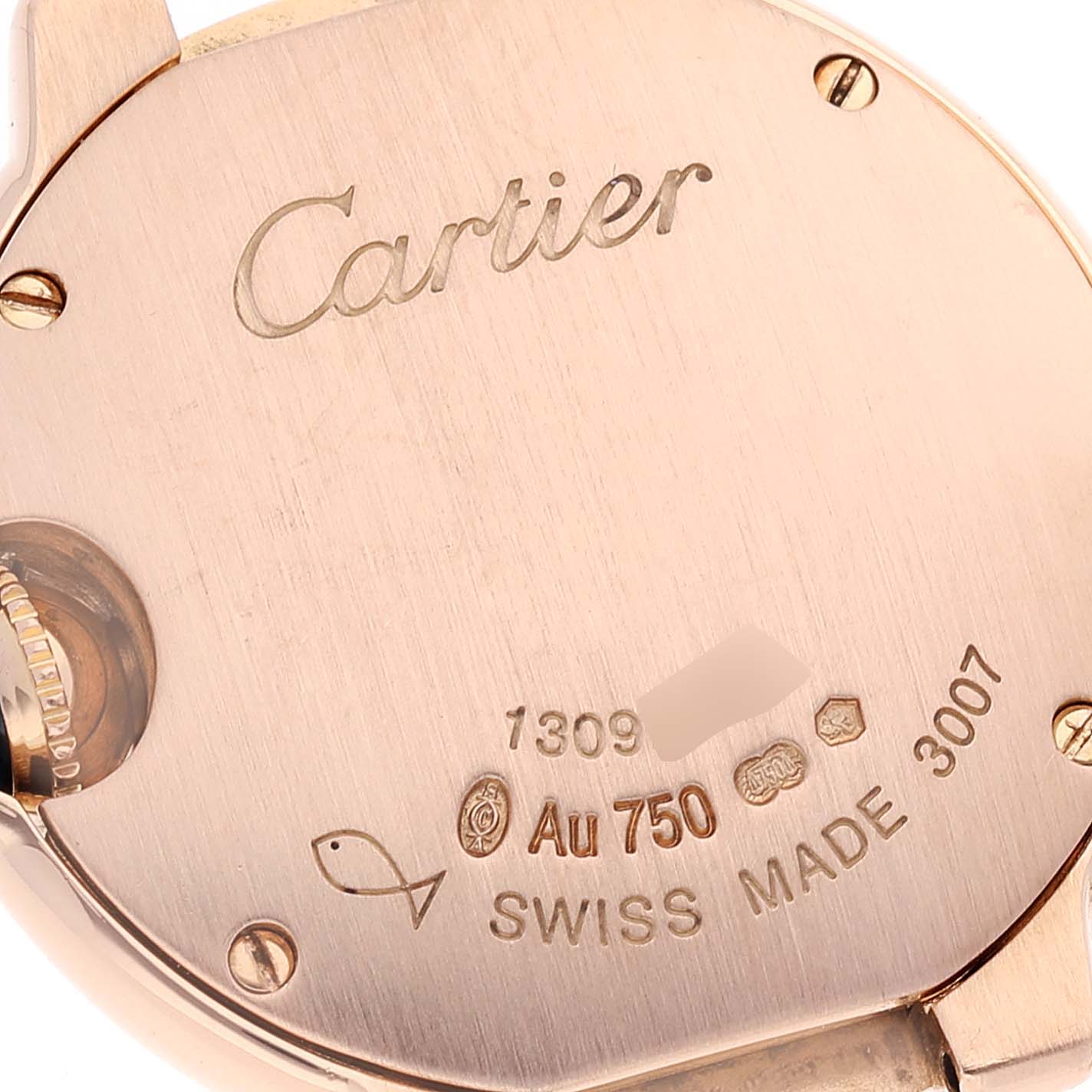 This image shows the back case of a Ballon Bleu model by Cartier, featuring engravings and hallmarks.