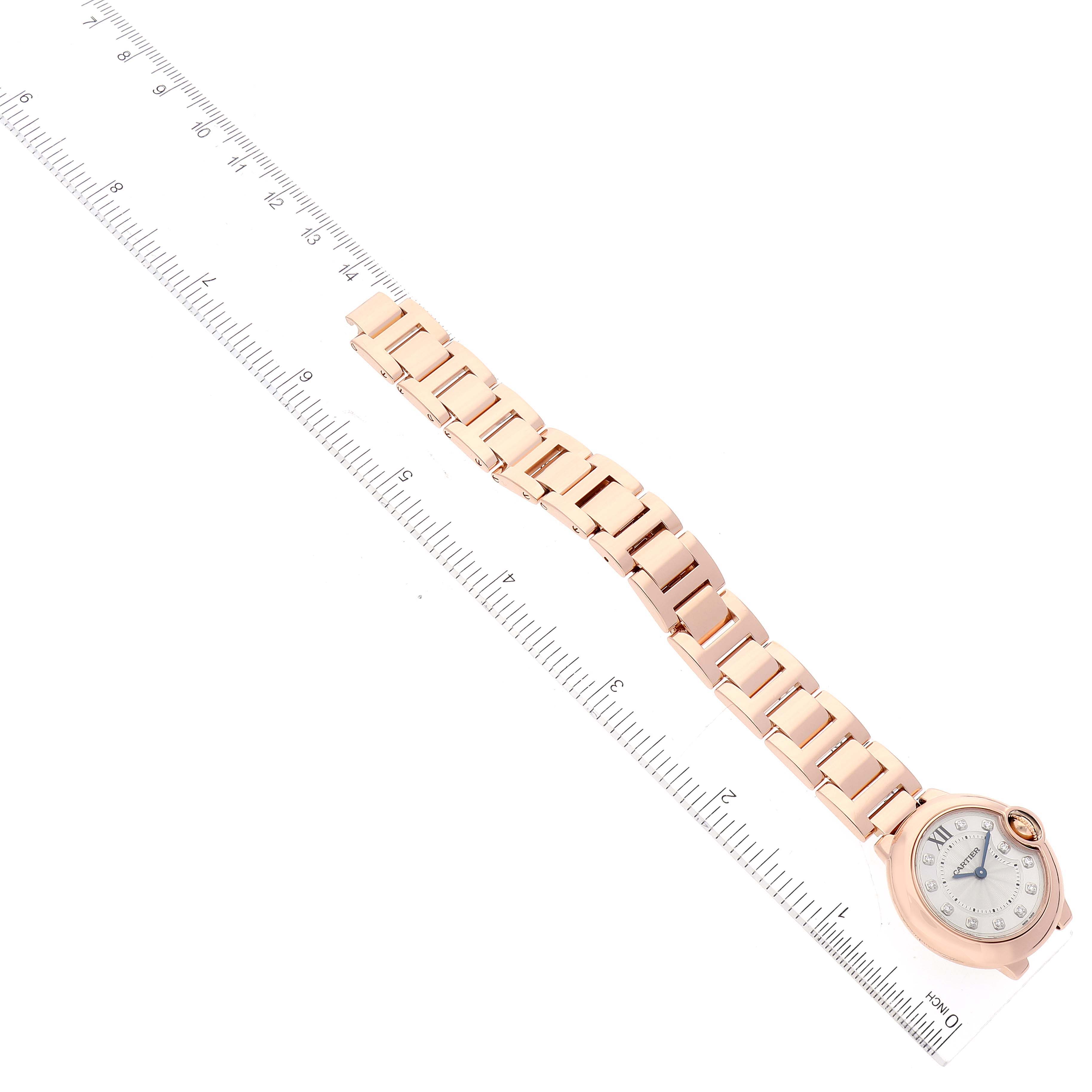 The image shows a side angle of the Cartier Ballon Bleu WE902025 Women's Rose Gold Silver Dial WE902025 Women's Rose Gold Silver Dial watch, displaying the face, bracelet, and a ruler beside it.