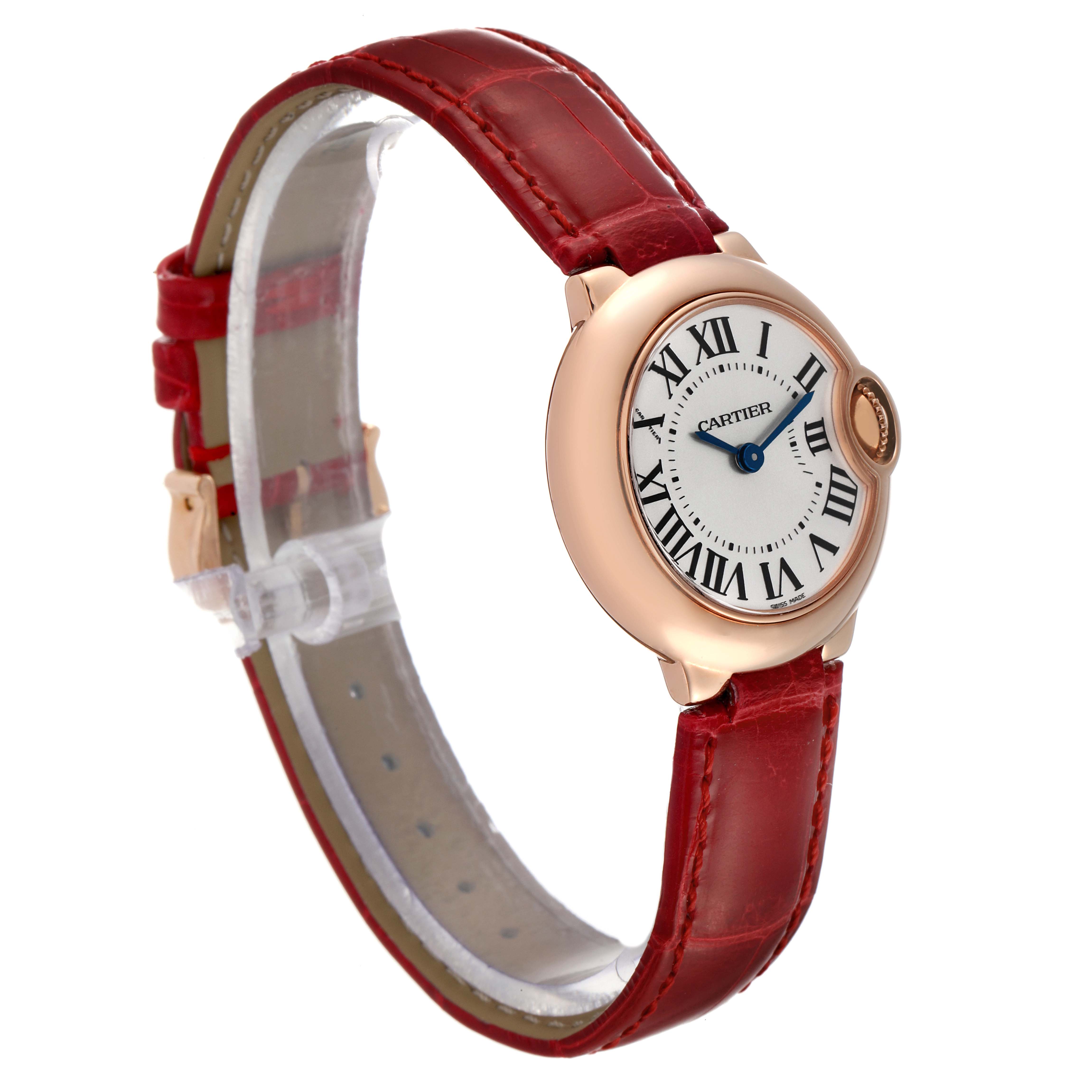 The Cartier Ballon Bleu W6900256 Women
s Rose Gold Silver Dial W6900256 Women
s Rose Gold Silver Dial watch is shown from a three-quarter angle, displaying its face, red leather strap, and side crown.