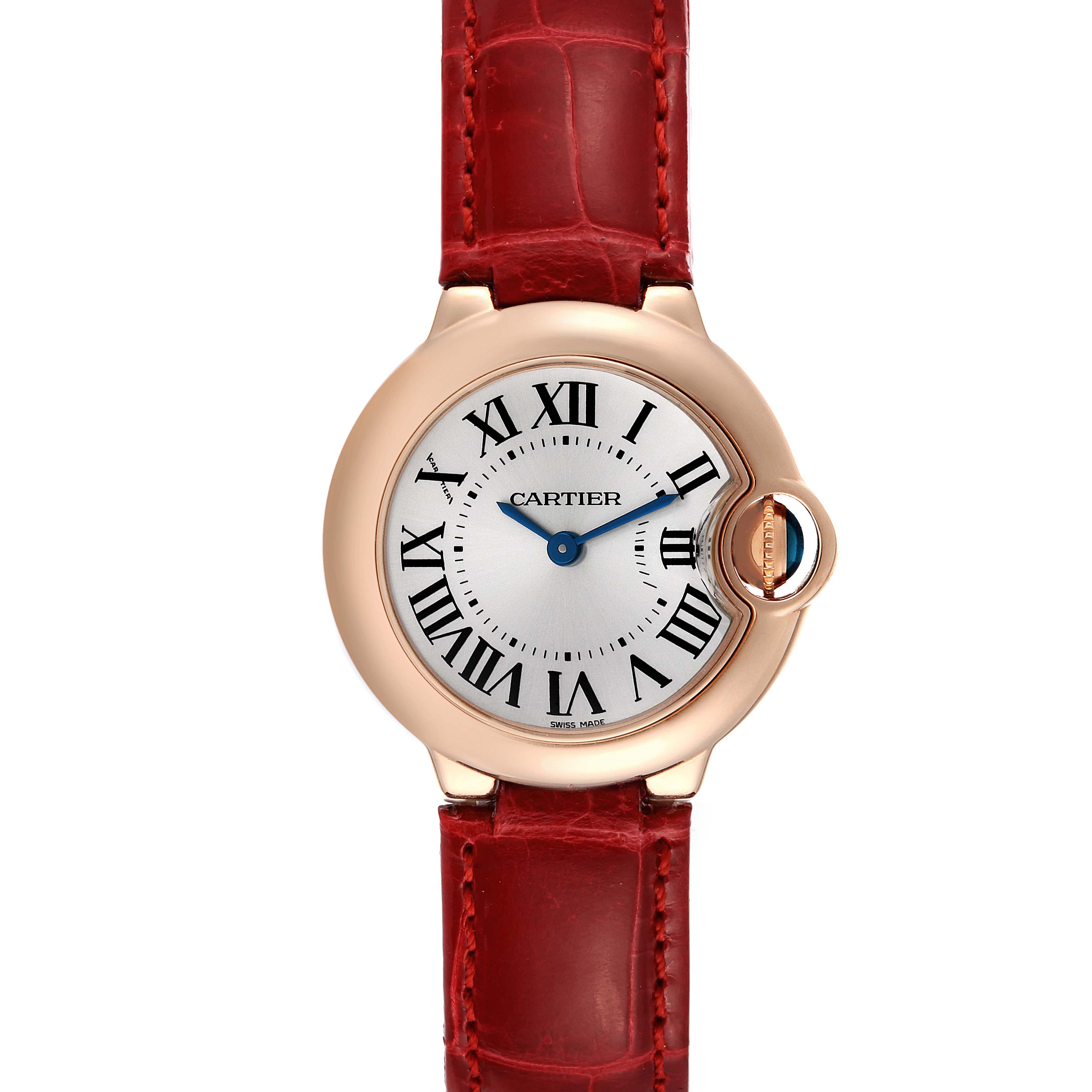 This image shows a head-on view of the Cartier Ballon Bleu W6900256 Women
s Rose Gold Silver Dial W6900256 Women
s Rose Gold Silver Dial watch with a red leather strap and a silver dial with Roman numerals.